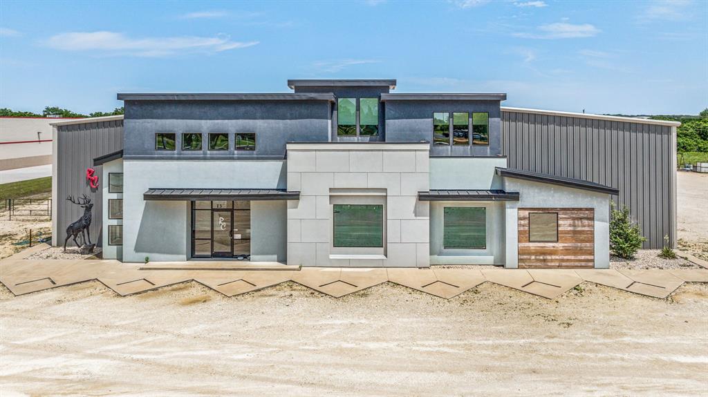 Welcome to a rare modern commercial property located in Stephenville, TX with approx 280 ft of hwy frontage on Hwy 281. This exceptional property sits on 3.2 acres and with its attractive facade and strategic placement, your business is sure to stand out. The open design invites collaboration and productivity with 4,220 SF of sleek, glass office space. Efficient with 4 offices, reception area, showroom, kitchen, and restrooms on the 1st floor. On the 2nd floor is an Exec office, addtl conference room, storage rooms, restroom. Spanning an impressive 23,312 SF the warehouse space is designed for productivity. 5 workspaces currently utilized for paint, welding, shipping, tools; some equipped with commercial ventilation including a spacious manufacturing area, breakrooms, and restrooms cater to the needs of your workforce. Seamlessly manage logistics with a loading dock, 2+ roll ups and 2,000 SF of separate storage behind the warehouse. This property is customizable to meet your needs.