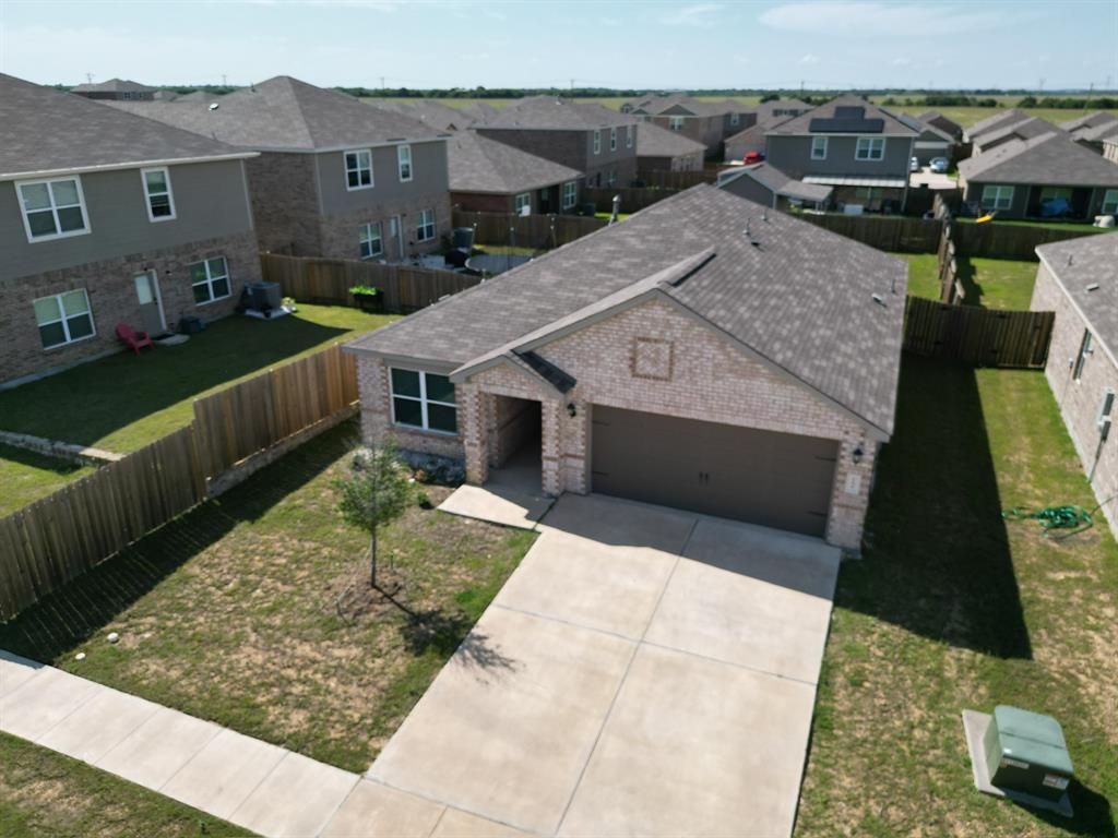 This is a modern, like-new single-story home with an open-concept layout. It features a spacious, naturally lit family room with soaring ceilings, ideal for gatherings. The chef-ready kitchen includes granite countertops, a kitchen island, stainless steel appliances, and a pantry. The primary suite offers a large walk-in closet, and there are two additional generously sized bedrooms. Interior finishes include ceramic tile, vinyl, and carpet flooring. It also has a tankless water heater, high-speed internet readiness. Located in the growing Patriot Estates community (Johnson County, Venus ISD schools). The neighborhood offers family-friendly amenities.
