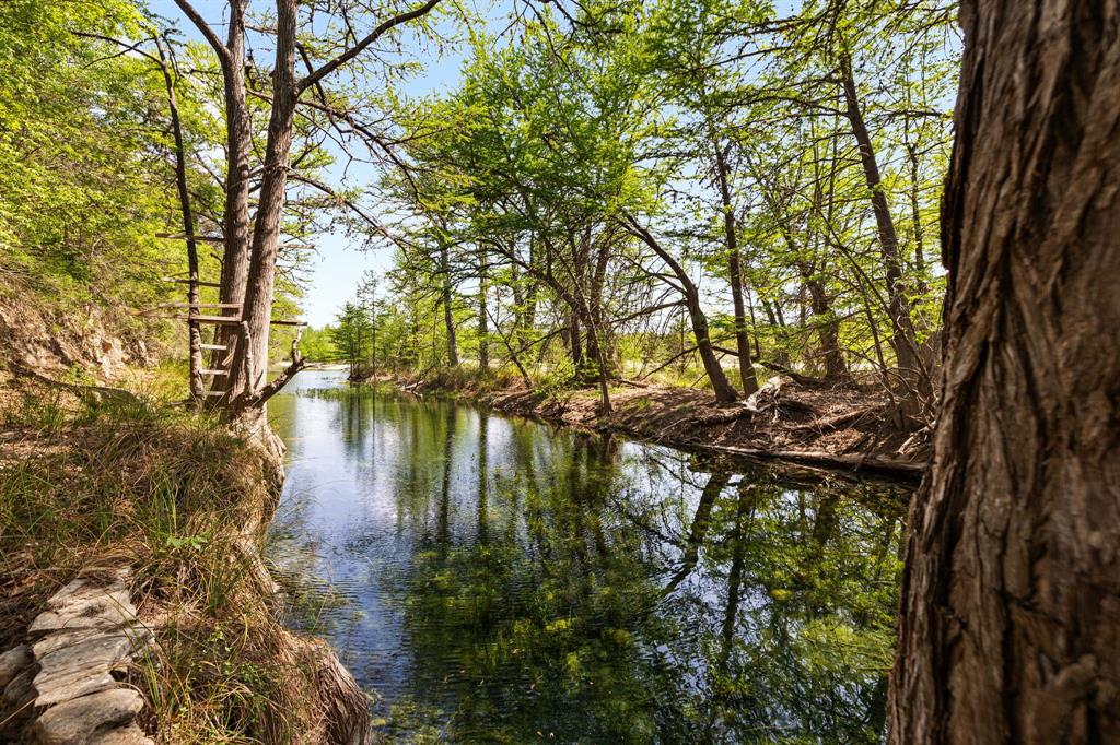The ~319 acre Medina River Ranch is located in Bandera County with gate access on Highway 16 and Medina River frontage. Highlights of this property include an ~460-foot elevation change from the highpoint at the back of the property to the front edge at the Medina River showcasing breathtaking views of the surrounding hill country.  The property boasts mature cypress trees along ~1,500 of Medina River frontage near the confluence of the Wallace Creek and the North Prong of the Medina River.  Current improvements include a water well servicing a mobile home with electricity, a septic system, and various barns and sheds. The property is fenced and cross-fenced for livestock needs. Wildlife includes Whitetail, axis, quail, turkey, dove, and hogs. With plenty of room to roam, The Medina River Ranch is a must-see property for anyone interested in Bandera County who is seeking immediate enjoyment but wants the opportunity to develop over the years to come.