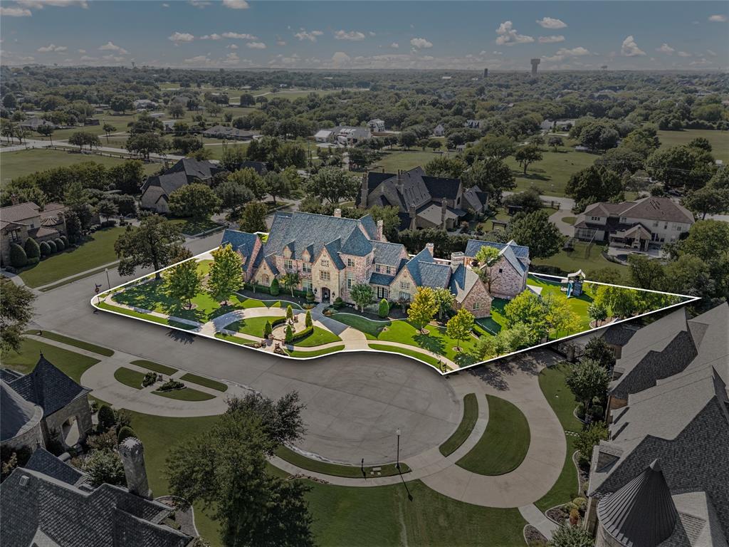 Positioned on a premier corner cul-de-sac lot in gated Castleton Manor, this extraordinary updated estate presents a rare opportunity to own a private compound in the heart of Colleyville. Spanning 10,026 sq ft across the main residence (8,601 sq ft) and fully detached guest house ADU (1,425 sq ft), the property blends scale, sophistication, and versatility on .921 acres. Originally designed and owned by a professional athlete, the home carries a sense of presence and legacy, now reimagined with light-filled interiors, soaring ceilings, and an open floorplan designed for elevated living and effortless entertaining.

The main residence offers expansive living and dining spaces, including a formal dining room, breakfast area, and oversized island seating. The chef’s kitchen with fireplace and wine storage flows seamlessly into the primary living areas, ideal for hosting and large groups. Additional highlights include: upstairs game room & play area with covered patio, private office, den with fenced patio to front yard, theater room, 2 versatile bonus rooms for use as a gym, yoga studio, craft space, home school, or more offices. The primary bedroom offers: sitting area with fireplace, en-suite bath, steam shower, 2nd laundry area, and large walk-in custom closet designed for storage & showcasing luxury items.

The detached two-story guest house ADU offers a private retreat with covered patio, balcony, bedroom, full bath, kitchen with wet bar, and multiple living areas, ideal for multi-generational living, guests, or live-in staff.

Outdoor living is elevated with a Claffey heated sports pool, spa, baby pool, fire & water features, safety gate; outdoor kitchen, 6 covered patios and balconies, plus a gated putting green and turf play area.

Designed for privacy, scale, & effortless entertaining in one of Colleyville’s most sought-after gated communities, this versatile home offers Everything for Everyone, a true lifestyle estate rarely found in today’s market.