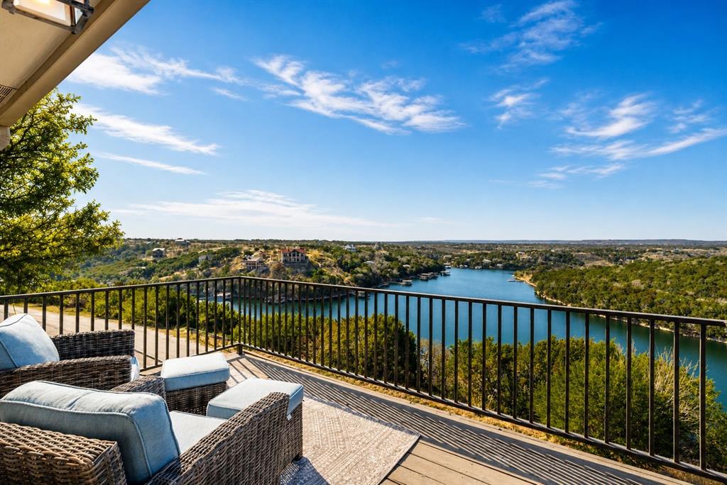 Exceptional waterfront estate property with transferable boat slip, a truly rare find. Experience refined lake country living in this exquisitely updated residence located within the prestigious, gated Cliffs Resort on Possum Kingdom Lake. Offering stunning lake views and a hidden vantage point for the iconic Hells Gate 4th of July fireworks, this beautifully fully furnished home showcases an exceptional blend of luxury, comfort, and resort-style amenities, making it a rare turnkey opportunity ready to enjoy from day one. The thoughtfully designed floor plan features three bedrooms, two and a half bathrooms, and two spacious living areas. A large eat-in kitchen anchors the home, offering ample countertop space and an inviting layout perfect for gatherings, while expansive windows capture breathtaking lake vistas throughout the living spaces. Recent enhancements include fresh exterior and interior paint, rich hardwood flooring creating a seamless, upscale aesthetic throughout. The primary suite is a true retreat, highlighted by a completely remodeled, spa-inspired primary bathroom designed for relaxation and sophistication. Elegant statement chandeliers elevate both the front entry and dining room, adding architectural interest and a strong sense of arrival. Outdoor living is equally impressive. Fresh landscaping surrounds the home with curated bushes, exotic plants, and stone accents. A rare second lot opportunity (MLS 21269271) expands the lifestyle possibilities, featuring a private spa-hot tub and a thoughtfully designed fire pit area with additional landscaping—perfect for entertaining or enjoying tranquil evenings under the Texas sky. For those seeking future expansion, the property includes two complete sets of architectural plans for a potential home addition, complete with multiple renderings showcasing pool and backyard concepts—an exceptional opportunity to further customize an already impressive residence.