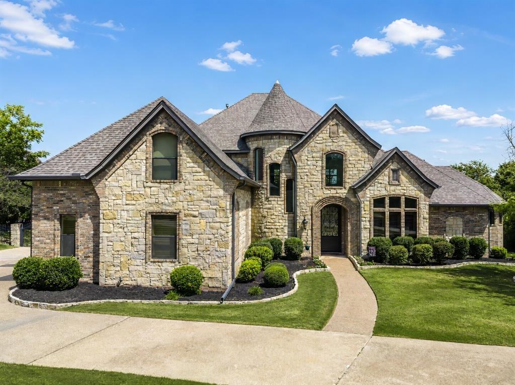Nestled within the prestigious gated neighborhood of The Waterfront, this extraordinary four bedroom, four bath luxury residence offers an unmatched blend of elegance, recreation, and resort-style living. Thoughtfully designed for both everyday comfort and unforgettable entertaining, this home is a rare opportunity to own a gorgeous fully custom home on a little over half an acre, just one block from Eagle Mountain Lake. Inside, you'll find spacious living areas and a state-of-the-art Uneekor golf simulator, creating the ultimate space for entertaining family and friends or perfecting your swing year-round! The backyard is truly a showstopper! Designed to rival a five-star resort, enjoy your complete private oasis featuring a stunning custom pool. This sport pool features a negative edge, elegant water features, and bubblers on the tanning ledge that creates a peaceful, resort-like ambiance. Relax in the hot tub, gather around the fire pit, or entertain with ease from the multiple levels of outdoor seating designed for unforgettable evenings. Golf enthusiasts will appreciate the private putting green, completing an outdoor retreat unlike any other. This exceptional property offers the perfect balance of luxury, privacy, and recreation. This is more than a home, it's a destination where every day feels like a vacation.This beauty is a must see and won't last long. Come take a look today!
