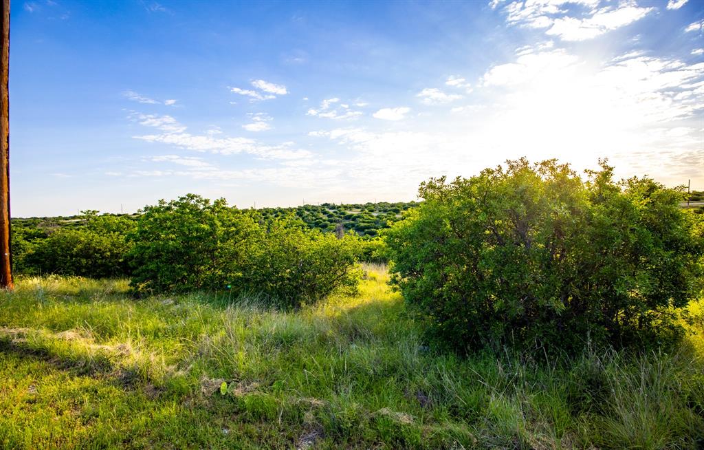 Hillside lot overlooking the natural and serene beauty of the landscape and creek bed below. This lot offers a great opportunity for buyers to build a multi level home with views throughout the whole house. Great for nature lovers or people seeking a quieter home site without sacrificing access to lake life and other perks. Ownership gives you access to the club house, 2 pools, tennis court, marina, restaurant, and 36 rounds of golf per year. This is a gated and guarded community, so you will need an agent to get access and view this unique community and lot.