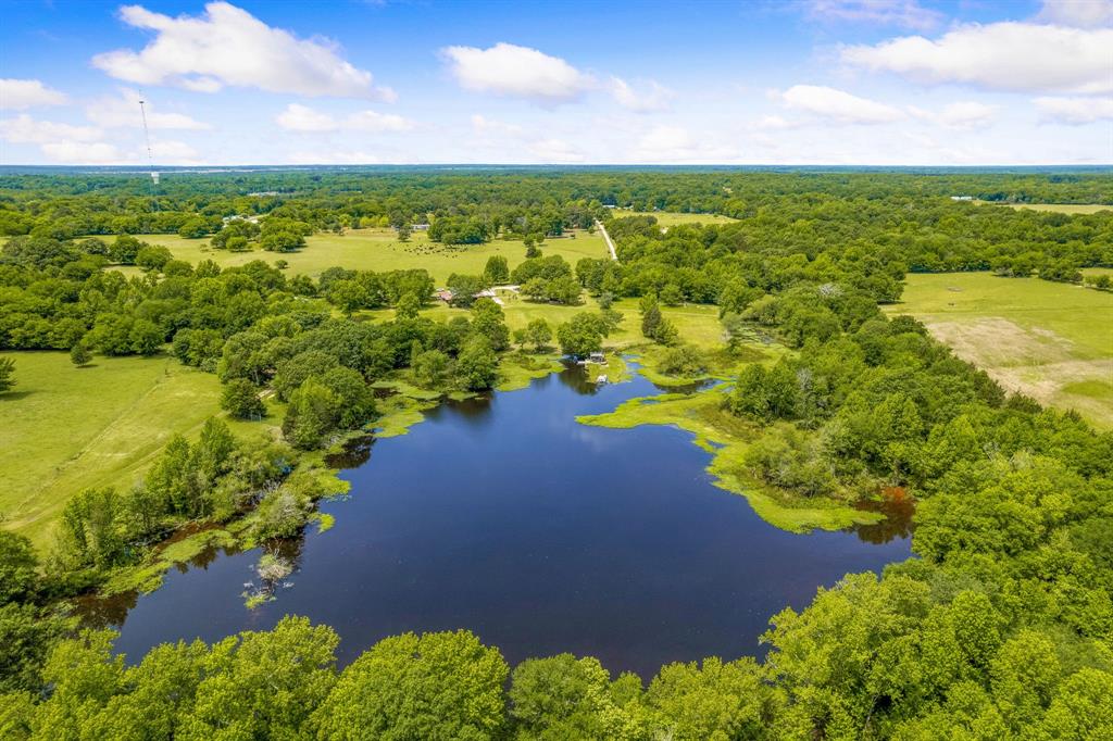 Located just 2 hours East of Dallas, this 241 acre ranch features a completely remodeled 3 bedroom ranch house, fully stocked 10 acre pond with large gazebo and upper deck, equipment shed, aviary and boundless possibilities! Native pasture land offers excellent haying opportunities, livestock grazing, and peaceful seclusion. As a recreational hunting and fishing ranch, you’re likely to see deer, boar, bass, catfish & more! You'll find 2 insulated Ranch King blinds, one 8ft x 8ft and one 8ft x 6ft on the property. Plus 40ft x 60ft equipment shed, 20ft x 20ft aviary for birds and barn all with electric & water. Retreat to the charming 2600 sq ft house with high end appliances including Sub Zero fridge, Wolf oven, Bosch dishwasher, wine cooler, granite countertops with custom cabinets, huge kitchen island & gorgeous wood flooring. Enjoy breathtaking views of nature and boundless recreation. Nearby access to electricity & water can be found on the Northern and Southern portions if needed.