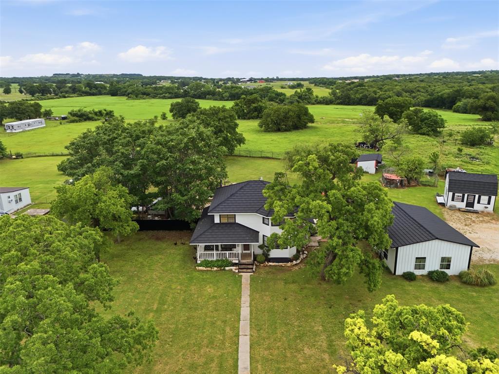 Experience the perfect blend of comfort and country living with this spacious 2,675 sq ft ranch-style home nestled on 9.22 acres in Paradise, TX. The property features productive hay fields and is currently ag-exempt, offering both beauty and functionality.
Inside, you’ll find an open floor plan designed for everyday living and entertaining, highlighted by a large eat-in kitchen with plenty of space for gathering. Step outside to enjoy a beautifully landscaped and manicured yard, complete with an in-ground pool—perfect for relaxing or hosting on warm Texas days.
Approximately 1.5 acres surrounding the homesite are cross-fenced, with the remaining acreage ideal for livestock, horses, or continued hay production. The property is well-equipped with corrals and livestock pens, along with a large metal parking and storage shelter and an additional outbuilding that can serve as a workshop or extra storage.
Mature, old-growth oak trees are scattered throughout the property, providing shade, character, and scenic views in every direction. The home is serviced by well water, with access to a water line at the front of the property for added flexibility.
Whether you're looking to establish a hobby ranch, raise animals, garden, or simply escape the city for peaceful country living, this property offers endless possibilities. Conveniently located just 8 minutes from Bridgeport, 15 minutes from Decatur, and 40 minutes from Fort Worth.