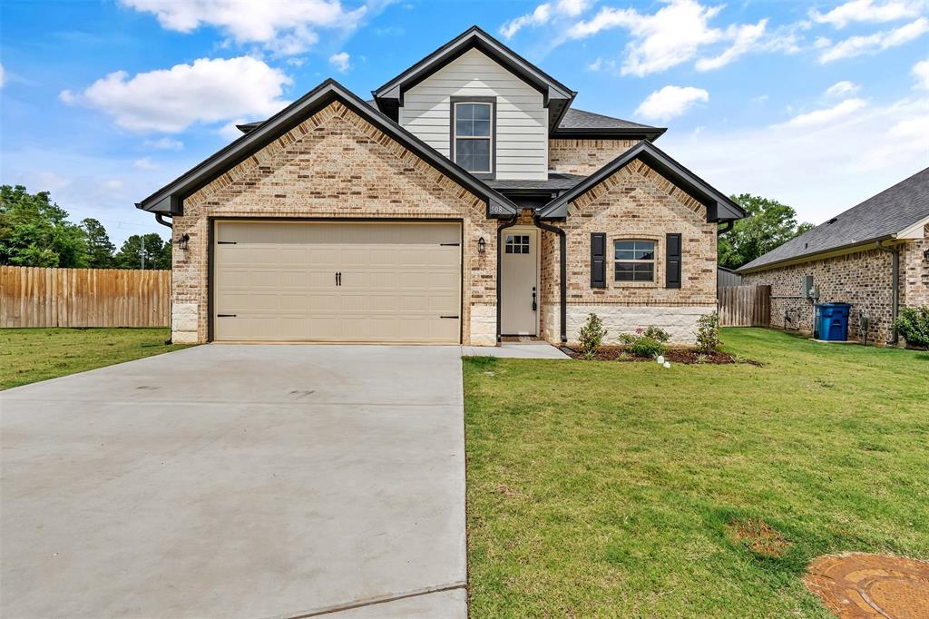 Beautiful new construction in Kingdom Estates offering 4 bedrooms, 2.5 baths, and a 2-car garage in highly sought-after Lindale ISD. Conveniently located near I-20, this home provides easy access for commuters traveling to the Dallas metroplex or east toward Shreveport, while still enjoying the charm of a City of Lindale subdivision with a peaceful country feel. Just minutes from the new west loop development in Tyler, the medical district, shopping, and dining, the location is ideal for a variety of buyers. Built by Kingdom Homes, known for their higher-end finishes and attention to detail, this home features an inviting open layout with luxury vinyl plank flooring throughout the downstairs. The kitchen is equipped with granite countertops, stainless appliances, gas stove, microwave, custom cabinetry, and stylish hardware. The spacious primary suite downstairs features a 10’ tray ceiling with crown molding and an ensuite bath with double sinks and walk-in closet. A laundry room and half bath complete the downstairs space. Upstairs offers 3 guest bedrooms (with FHA approved carpet and pad)that share a full hall bath. Additional highlights include an impressive 8’ front door, tankless water heater, covered back porch with large backyard with plenty of room for a pool and play space, plus a 1-2-10 warranty for added peace of mind. Neighborhood amenities include a pickleball court, basketball court, pavilion, dog park, horseshoe area, walking trail, playground, and sidewalks.