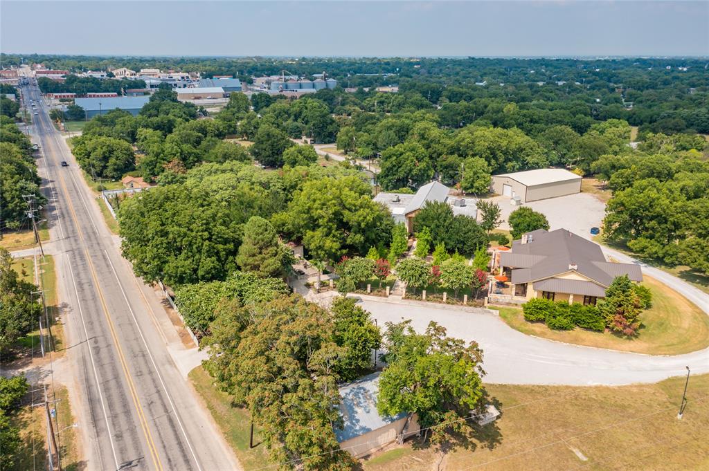Located just half a mile from the charming and historic Town Square, in Comanche, Texas, this 3.5-acre property offers a rare opportunity to acquire a highly versatile, fully improved campus with a wide range of potential uses. For the past 20 years, the property has been home to a successful winery. Today, it stands ready for a new owner to continue that legacy or repurpose the site for distillery, brewery, retail, hospitality, restaurant, short-term rental, or mixed-use concepts.

The property offers an uncommon combination of history, functionality, and aesthetic appeal, anchored by significant improvements and abundant infrastructure. Key features include:

Historic 1,800 sq ft Limestone Residence (Late 1800s)
• Designated historical marker
• Original limestone construction with classic architectural character
• Updated interior with modern amenities and finishes
• Ideal as an owner’s residence, B&B rental, tasting-room annex, or executive office
7,700 sq ft Multi-Purpose Building
• Full commercial kitchen suitable for restaurant, event catering, or production support
• Expansive covered porches offering outdoor hospitality space
• Large outdoor fireplace enhancing event and customer-facing potential
• Climate-controlled basement suitable for storage meeting rooms, etc….
5,700 sq ft  Production Building
• Former production and hospitality facility
• Accented with multiple large, handmade antler chandeliers and sconces
• Roll-up doors providing access to a substantial loading dock
• Flexible footprint suitable for production, events, retail, or adaptive reuse
4,000 sq ft Climate-Controlled Metal Storage Building
• Ideal for inventory, equipment, barrel storage, or conversion to additional production space

Location Advantages
• Approximately 0.5 miles from Comanche’s historic Town Square
• Close proximity to restaurants, retail, entertainment, and hospitality venues
• Easy access for tourists, wine trail visitors, and regional travelers