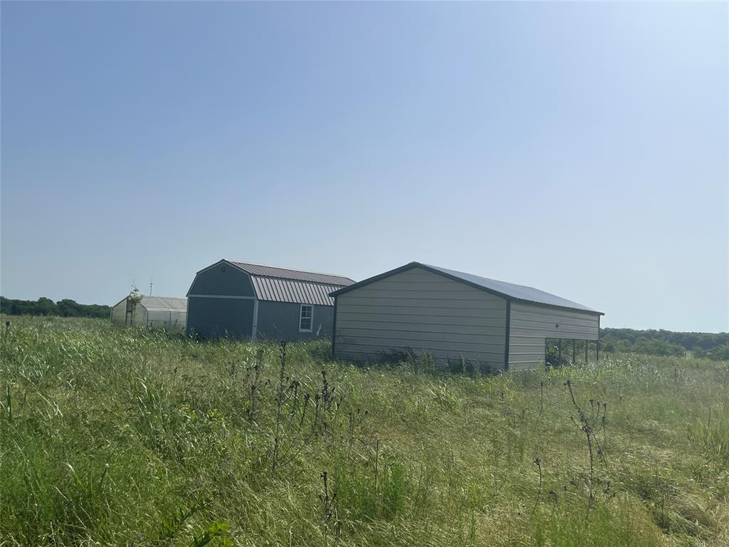REDUCED! Looking for acreage in BOLES ISD? Here's 15.34+-acres with no known restrictions. Open land and a few trees with a gentle slope that leads to the back acreage, partially fenced, 2 car carport, storage building, and a green house all sitting off the road giving some seclusion. Property offers a water well and electricity pole. This is an estate sale with an attorney as Admin. All offers and final sale will need to be approved through Dallas County Probate Court. Please, allow plenty of days to gain approval for the offer and closing! No survey in file.