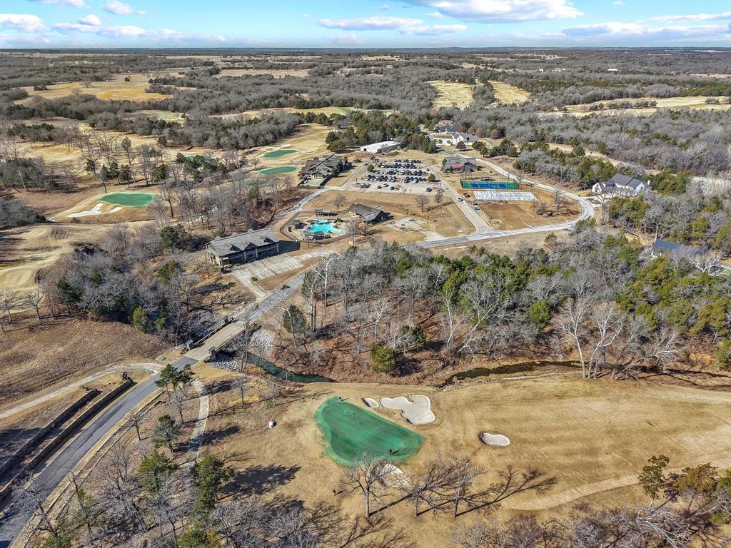 Build your dream home on this beautiful lot nestled within a premier country club community, perfectly positioned along a lush green golf course. Corner lot on 15 green to be exact! Bad day on the course? Just stroll right on home and skip the last three holes. Start practicing not only your swing, but your wave as you're riding around your golf cart passing neighbors. Nicest lot in Rock Creek if you ask me. Perfectly set along a gorgeous green golf course—where the views are great and the only balls you’ll see flying are on the fairway! Enjoy serene views, manicured fairways, and the peaceful lifestyle that comes with country club living. Residents have access to first-class amenities including a stunning clubhouse, resort-style pool, and on-site restaurant—ideal for both everyday enjoyment and entertaining guests. Located just minutes from the sparkling waters of Lake Texoma, this property offers the perfect blend of recreation, relaxation, and refined living. Whether you’re envisioning a weekend retreat or a full-time residence, this exceptional lot provides the setting to bring your vision to life. Become a winner by owning the nicest lot available.