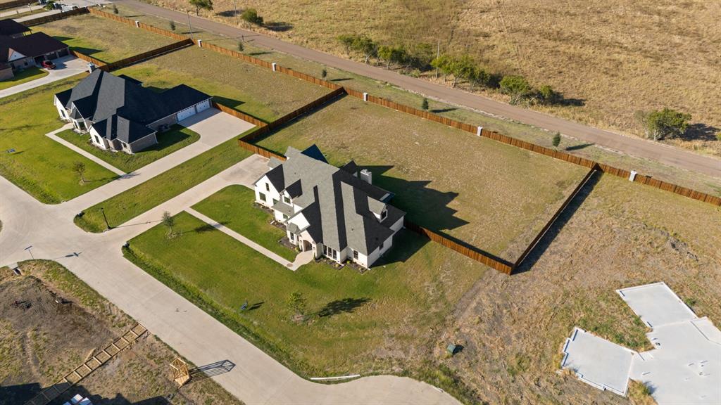 EXQUISITE COUNTRY LIVING AT ITS FINEST! This NEW QUALITY CONSTRUCTION HOME with all the Right Space sits on an ACRE LOT in a luxurious GATED EQUESTRIAN COMMUNITY with NO CITY TAXES! This community has so much to offer from a STOCKED CATCH & RELEASE POND for the Kiddos, STABLES for Boarding the Horses, PLAYGROUND, 3 Mile Riding Trail, ARENA, ROUND PIN, Full Service Equestrian Center & the List Continues*This Master Planned Community is located just 35 minutes from Dallas & will have Additional Amenities Added Soon like a Club House, Fitness Center, Poker Room & more*Beautiful Spacious OPEN FLOOR PLAN with gleaming HARDWOOD FLOORS & an Impressive Double Access Staircase with a Modern Flair as you step into the Home off the Entry*Formal Living Room or Flex Room off the Entry*Formal Dining Room*Living Room opens to the Gourmet Kitchen with Built In Cabinets & Shelving & a Floor to Ceiling Fireplace*Stunning Kitchen with tons of Custom Cabinetry & Quartz Countertops to entertain your guests, Pot Filer, Nice Appliance Package*Large Primary Ensuite Bedroom with Gorgeous Spa Like Bathroom with a Free Standing Tub, Separate Shower with Body Sprays & 2 Large Walk In Closets with Cabinets & Shelving only Bedroom located Downstairs*Entertainers Home with 2 Half Baths Downstairs for your Guests*STUDY*Massive MUD ROOM with extra Cabinets*Unbelievable Laundry Room with Cabinetry, Sink, Folding Area with tons of Countertops*Bonus Room with more Cabinetry use as you deem fit*Flex Room*HUGE GAMEROOM*MEDIA ROOM*Spacious Secondary Bedrooms...one is an Ensuite with its own Bathroom, All Upstairs Bedrooms have Cabinets under the Windows with a Window Sitting Area, all Bedrooms are Large, 2 Bedrooms have a Jack & Jill Bath*Another Bonus Room Upstairs*Massive Covered Patio in the Backyard*3 Car Oversized Garage*EXPERIENCE LUXURY COUNTRY LIFESTYLE, SUNRISES & SUNSETS! COME SEE TODAY! Some photos are virtually staged to show possiblity.