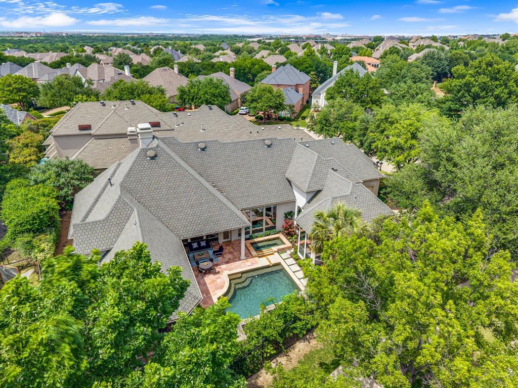 Masterfully built by Steve Roberts on a private cul-de-sac in the guard-gated Starwood community, this single-story residence offers a refined blend of timeless craftsmanship and architectural elegance, centered around a private pool oasis. From the moment you arrive, an inviting entry with dramatic vaulted ceilings & a designer chandelier welcomes you. The elegant formal dining room features a butler’s pantry complete with illuminated glass cabinetry, beverage refrigerator, and ice maker—perfect for entertaining. The chef’s kitchen is designed for both everyday living and hosting, showcasing abundant cabinetry, breakfast bar, island, Sub-Zero glass-front refrigerator, five-burner gas cooktop, stacked oven and microwave, warming drawer, and premium stainless steel appliances. The spacious family room is a true showpiece with vaulted beamed ceilings, custom built-ins, a floor-to-ceiling fireplace mantel, a striking chandelier, and expansive windows overlooking the tranquil backyard oasis. The private primary suite offers a cozy sitting area and spa-inspired bath with dual vanities, oversized frameless glass shower, jetted tub, barrel ceiling, & an impressive custom walk-in closet. Additional highlights include a handsome study with pocket doors, a guest suite with a private bath, and an additional ensuite bedroom. Step outside to your professionally landscaped backyard retreat featuring a covered patio, sparkling pool and spa, beautiful stone privacy wall with soothing waterfalls, and lush landscaping creating exceptional privacy and serenity. Recent upgrades include one replaced AC unit, all new window screens, & enhanced professional landscaping throughout. Easy hop onto DNT for your commute and prime Frisco location near The Star, Shops at Legacy, Grandscape & so much more.