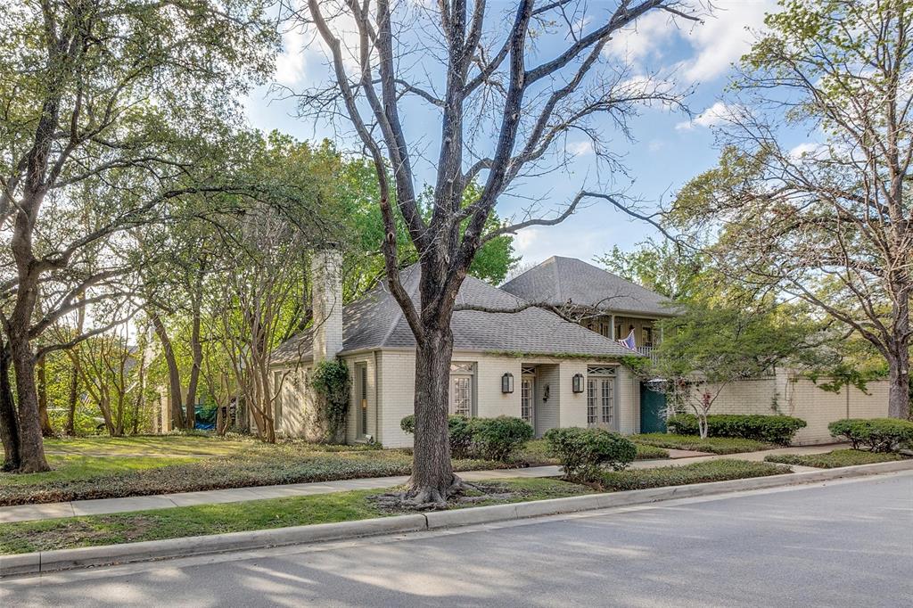 Wonderful New Orleans style architecture with both charm and elegance! The U-shaped home wraps around a large courtyard and pool which is viewed by most living areas. Five French doors open from the living areas to outside. The lovely oversized living room has pickled wood beams, fireplace, brick floors; large dining room which opens to outdoors is great for entertaining. Kitchen with island and 2 pantries is open to spacious breakfast room and overlooks courtyard. A den or study downstairs is adjacent to the primary bedroom which has 2 walk-in closets, 2 dressing areas, extra office. There are 2 secondary ensuite bedrooms up with French door access to upstairs covered balcony. Excellent attic storage and attached 2 car garage