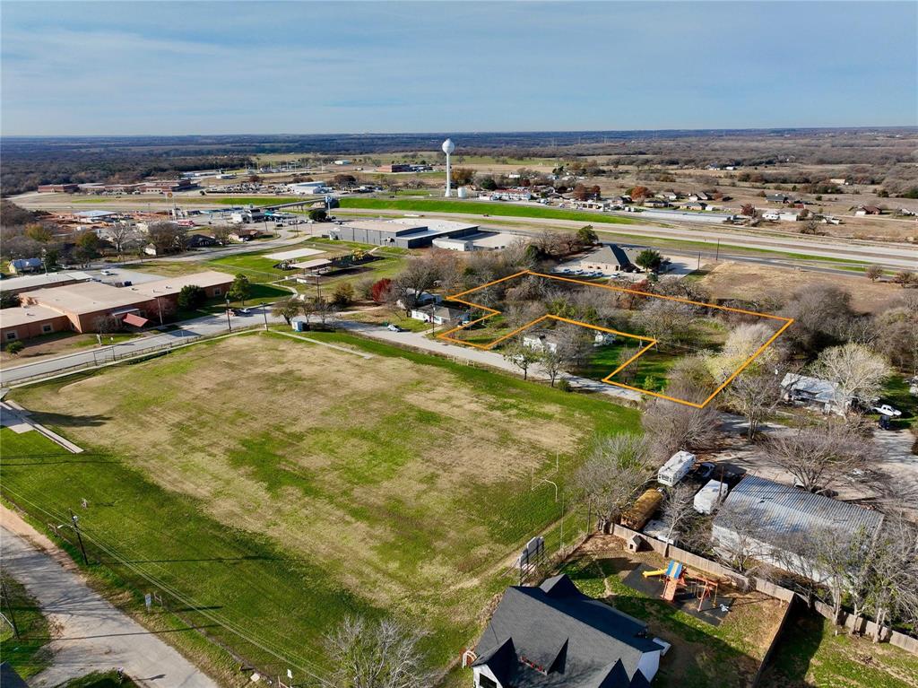 Beautiful 1.77 acre lot available in Alvord ISD with potential for future subdividing. Nice mature trees, city water, and city sewer available along the road, this could be a great investment property for a quickly growing town only 45 minutes from Ft Worth. Located across the street from an open field used for football, this is an expansive lot that could be used as a large town lot for a nice residence or continue forward with the platting process to create up to 8 lots for single family residences. Whether it be for immediate use or an investment for the future, don't miss out on your chance to own a nice lot in the growing town of Alvord, TX.