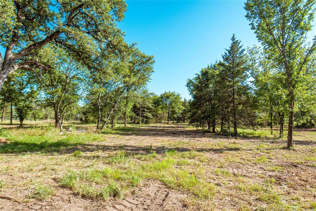 Back on Market, Buyer's financing fell through.  Beautiful, treed, 1 acre lot with beautiful build sites.  Trees, sandy soils, abundant wildlife and beautiful surroundings all make this a great location for your dream home.     Water and electric available.  Septic required.   Highly rated Callisburg Schools.  Low property taxes - no city tax.  No HOA.  Manufactured homes welcome.
