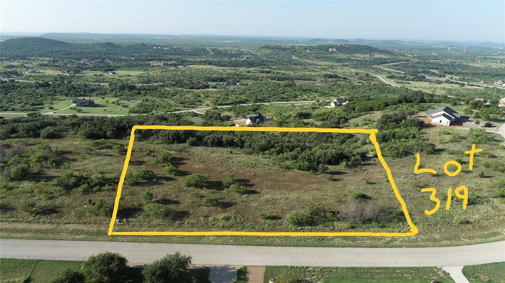 This sprawling two acre lot has approximately 250 feet on  the front, transformer to transformer as you stand on Shooting Star, which is a popular street at The Hills above Possum Kingdom Lake.  Plenty of room to create your oasis and dream lake home. Ideas include a secondary building, outdoor kitchen and patio, swimming pool, garden, or all of the above! You build on your own time frame with your builder of choice.  Minimum 2500 sq ft home. No manufactured homes or metal homes like barndominiums are allowed. No parking of RVs on property while building.  Electricity and water available on the property.  The stars really are  brighter here in the heart of North Texas hill country.  While you wait to build or are building you will enjoy the upscale amenities of a gorgeous community clubhouse, infinity pool, and workout facility overlooking the lake, community lake cabin, boat dock, watercraft launch, as well as boat storge. POA dues are $950.00 per year. The weather is cooling down and this is a great time to come out and walk the property and visit the amenities!