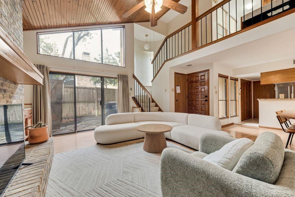 Tucked away on a quiet cul-de-sac in East Dallas, this architecturally distinctive residence blends modern design with warm, natural elements to create a home that is both refined and inviting.

Vaulted wood-plank ceilings and expansive windows define the main living space, filling the home with natural light and drawing the eye upward. A striking brick fireplace anchors the room, while built-in shelving and thoughtful detailing add both character and function. Sliding glass doors create a seamless indoor-outdoor connection to the private patio.

The kitchen is both stylish and practical, featuring granite countertops, stainless steel appliances, and warm wood cabinetry, all flowing easily into the dining area—ideal for everyday living and casual entertaining.

The primary suite is located on the main level and is highlighted by vaulted ceilings, natural light, and direct outdoor access. The primary bath offers a split layout with a dual-sink vanity and freestanding soaking tub on one side, and a separate single vanity, glass-enclosed shower, and toilet on the other.

Upstairs, a versatile loft overlooks the living area below, offering a flexible space for a home office, reading nook, or secondary lounge. A private secondary bedroom and full bath offer flexibility for guests or additional living needs.

Outside, the wraparound patio and turf yard offer a low-maintenance outdoor setting with multiple areas to relax or entertain, all within a gated, private space. The neighborhood also connects to Sopac Trail — which provides direct bike & walking access to White Rock Lake.

With its distinctive architectural character, functional layout, and convenient location, this home offers a rare opportunity to enjoy both thoughtful design and everyday livability in one of East Dallas’ most accessible neighborhoods.