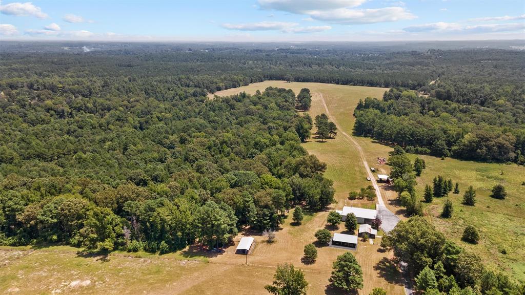 The more than 350 acres of your own paradise boasts over 200 acres of beautifully-thinned, 18+yr old pine plantation. There are also many acres of mixed hardwoods & pine tree forests that draw in & hold wildlife from all around. There are numerous deer on the property, along with a great pond, & several streams. There are already feeders & deer stands in place, not to mention its nearly 8mi of trails that make the entire property accessible and fun for ATV riding. There is a large open field on the property that is one of the highest points for miles around. This would make a phenomenal place to build your dream home. There is already a very nice shop with a very well finished 2br 1ba living quarters with central AC, kitchen, laundry, living area, dining area, etc. Outside the shop is another unique storage & porch area, along with a 40x50 covered party area with electricity, fans, tables, etc. There is also a covered & fenced area with 6 kennels and a feed storage room.