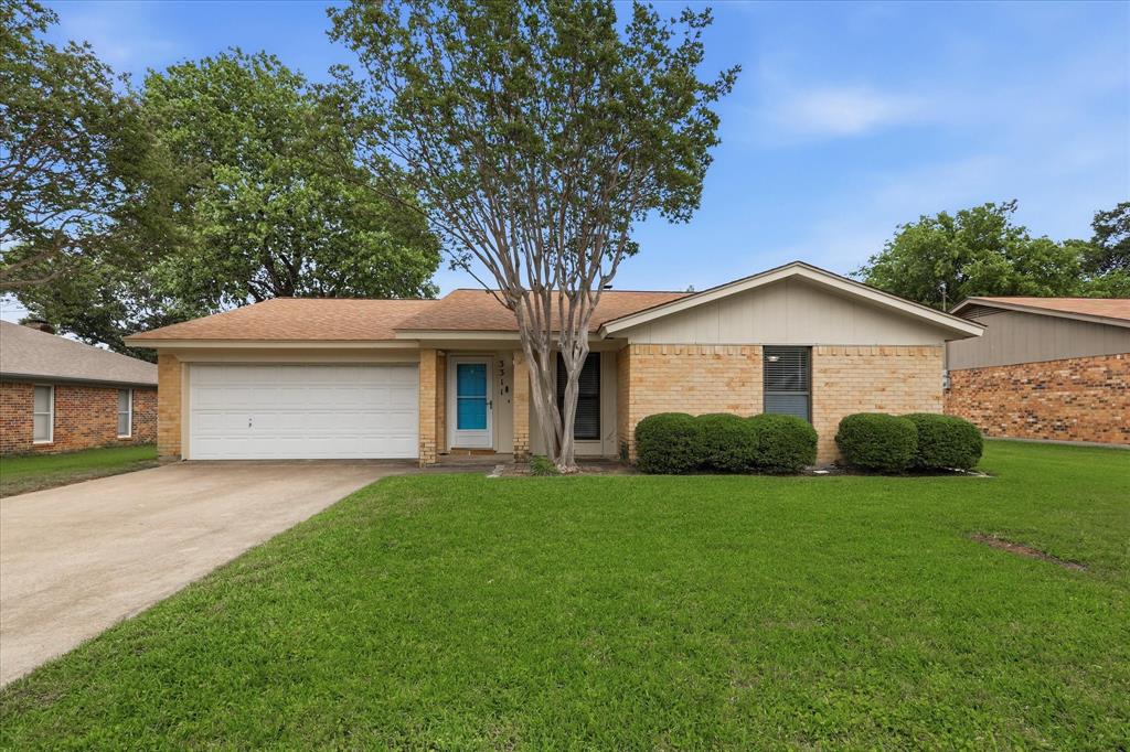 Nestled in one of the much-loved neighborhoods surrounding Martin High School, this charming traditional ranch-style brick home offers the perfect blend of comfort and character. Whether you are a first-time homebuyer or looking to downsize without sacrificing space and charm, this inviting home is ready to welcome its next owners.
From the moment you arrive, the welcoming blue front door and classic curb appeal set the tone for what awaits inside. The sunken living room immediately captures your attention with its beautiful brick wood-burning fireplace and raised hearth, the perfect centerpiece for cozy evenings, seasonal décor, and gathering with family and friends. The open flow between the living room, dining area, and kitchen creates a comfortable and connected living space ideal for both everyday life and gatherings.
The kitchen is filled with timeless charm featuring beautifully maintained original woodwork, abundant storage, and a built-in buffet with upper and lower cabinetry for added functionality and character. From the kitchen sink, enjoy peaceful views of the backyard.
On the opposite side of the home, you’ll find three generously sized bedrooms and two full baths. The primary suite offers the rare bonus of two walk-in closets, providing exceptional storage space.
Step outside to enjoy the extended covered patio overlooking the backyard — a wonderful setting for gardening, playtime, barbecues, or simply relaxing outdoors.
Important updates provide peace of mind, including a new HVAC system in 2026, and a roof replaced in 2025, both with warranties. The hot water heater has also been updated, and the front yard is equipped with a Rain Bird sprinkler system for easy lawn maintenance.
Conveniently located near highways, schools, parks, shopping, and dining, this charming Arlington home is filled with warmth, character, and opportunity, ready for new owners to make it their own.