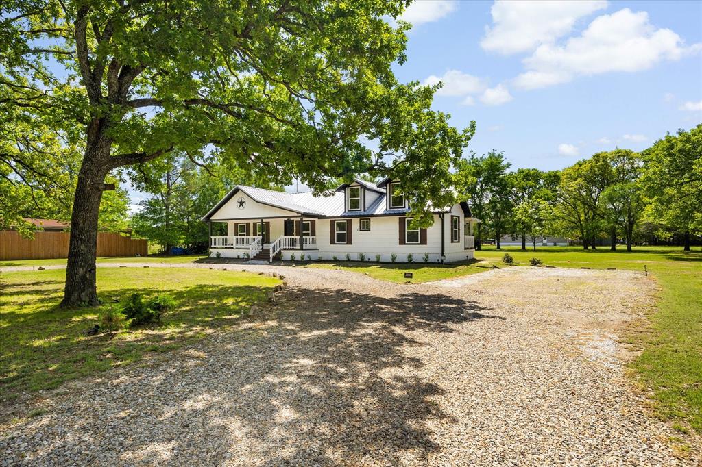 THIS IS A PERFECT WEEKEND RETREAT OR HOMESTEAD, for those wanting to escape to a quiet and private setting with no traffic or HOA!.  Sit back and watch the deer, birds and other wildlife from your porch, surrounded by large, picturesque mature trees. Country living but close to City amenities… This charming pier-and-beam home offers 3 bedrooms and 2 baths, nestled on just under one acre with a large front porch and back porch, perfect for soaking up the quiet escape and peaceful setting! The home was almost completely rebuilt in 2022.
Ideally located just 15 minutes east of Rockwall, this property provides the perfect balance of privacy and convenience. Inside, the bright and airy updated kitchen showcases granite countertops, stainless steel appliances, and luxury vinyl plank flooring. The Primary bedroom is oversized with a beautiful full bath with dual sinks, walk in shower, stand alone tub and walk in closet.  Washer, Dryer, refrigerator and a Riding Lawn Mower will stay making this home ready for you!! The owner has made numerous improvements, including a new aerobic septic system, reworked plumbing, a covered back porch, added privacy fencing, seamless gutters, and enhanced landscaping, along with many additional improvements!
Meticulously maintained and thoughtfully updated, this home is pristine and truly move-in ready—an ideal retreat for those seeking tranquility without sacrificing accessibility. This beauty qualifies for an USDA Loan,  ZERO down for a lucky Buyer!!
