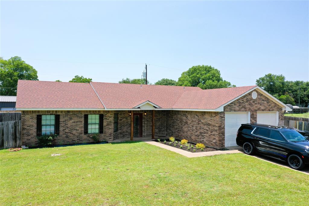 This spacious 4-bedroom, 2-bathroom property features a wide-open concept designed for seamless movement, highlighted by brand-new laminate flooring stretching throughout the entire house, 3-foot wide doors, and open entryways. The large kitchen has abundant cabinetry, a smooth-top range, microwave vent-a-hood, refrigerator, and a convenient breakfast bar. It flows effortlessly into the living room, which shines with a dramatic pop-up ceiling and a cozy gas log fireplace. Perfect for entertaining, the adjacent dining room easily accommodates a 10-person table and offers direct access to the covered patio.Privacy is paramount with a split-bedroom layout that separates the primary suite from the three additional bedrooms. The private primary bath has a jetted tub, separate tile shower, and a cultured marble vanity. Functional bonuses abound, including a laundry room positioned near the kitchen that doubles as an office desk space with overhead storage cabinets. Practical updates include a central heating and air system replaced approximately two years ago. Complete with a front-entry two-car garage, a massive backyard secured by a privacy fence, and an included storage building, this home perfectly blends accessibility, comfort, and modern style.