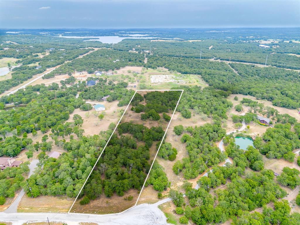 Tucked among mature trees, this 5-acre lot in Silver Lakes Ranch offers a private, peaceful spot to build your dream home or weekend retreat. The property itself is a blank canvas, while the surrounding community provides rolling hills, native grasses, wildflowers, and plenty of deer, wild turkeys, and birds to enjoy year round. Here, you can have seclusion without sacrificing conveniences. Silver Lakes Ranch amenities include two private fishing lakes, a community pool, fitness center, clubhouse, RV camping for property owners, and miles of scenic roads to explore on foot or bike. On weekends, Amon G. Carter Lake is just minutes away for boating, swimming, or a quiet day of fishing. The town of Bowie is close by for groceries, dining, and small-town charm, while the Metroplex is still within reach for work or city adventures. With its natural beauty, mature trees, and welcoming community, this property is a beautiful spot to put down roots and make it your own.