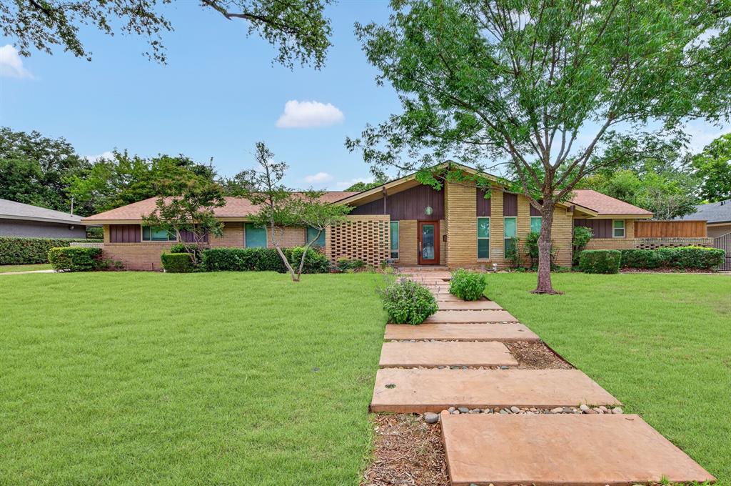 Spacious 4 bedroom, 3 full bath soft contemporary home with 1 covered RV or Boat parking spot in back yard with power in addition to 2 car garage and remote gate to backyard on .38 acres. Home is 2458 sq ft with huge 15X33 enclosed sun room with skylights and HVAC.  Split floor plan with separate guest room and private bath and 2 closets near kitchen.  Hard surface on all floors, no carpet.  New wood blinds, fresh paint.  Kitchen has lots of counter space with granite tops, double-oven, flat glass cook top & large stainless steel sink with reverse osmosis water.  SS refrigerator is included and brand new dishwasher.  Breakfast area looks out on to mature landscape & flowers.  Master bedroom has private patio door leading to private back patio sitting area.  Both full bathrooms have been totally updated.  All windows and doors are insulated plus extra insulation in attic.  Solar tube in main bath and kitchen for added natural light. Two HVAC units in home. The wonderful Katie Trail hike and bike trails are only 2 blocks away.  Home is centrally located so access to DFW & downtown are easy with Tollway.