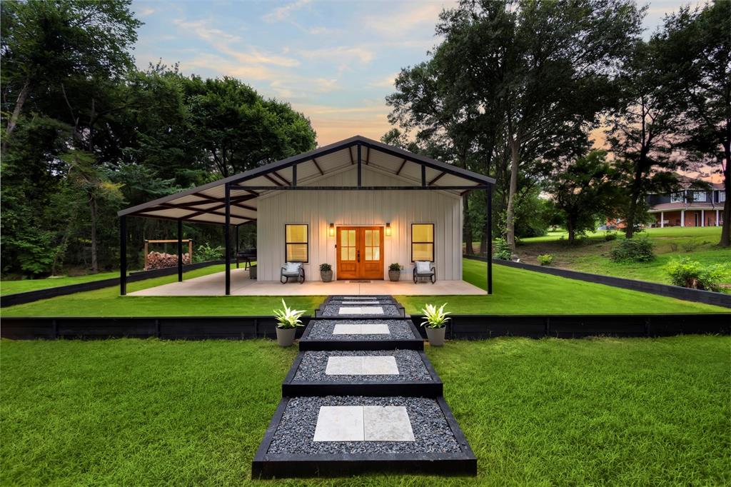 Nestled on just over 1.5 wooded acres in Scurry, this custom-built home offers the perfect blend of modern style and peaceful country living. Tucked behind mature trees with a spring-fed creek running alongside the property, this private retreat features an open-concept floor plan with soaring vaulted ceilings, abundant natural light, and designer finishes throughout. The spacious kitchen boasts beautiful countertops, a large island, farmhouse sink, custom cabinetry, and stainless steel appliances. The inviting living area centers around a floor-to-ceiling fireplace, creating a warm and welcoming gathering space. 2 bedrooms are downstairs along with 2 bathrooms and full size utility room. Upstairs, a versatile loft provides additional living, game room, or flex space. Enjoy the outdoors from the covered patios overlooking the serene wooded setting.