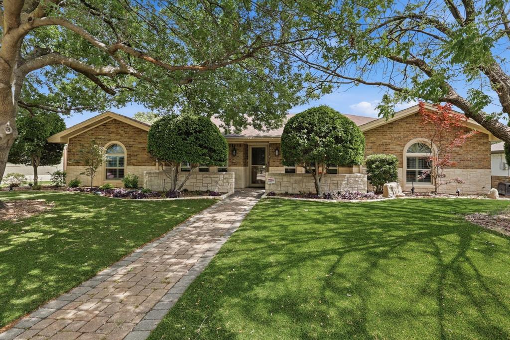 This pristine, one-owner home in the heart of Plano ISD offers a rare combination of meticulous maintenance and high-efficiency upgrades. Ideally positioned minutes from shopping, parks, walking trails, Plano Aquatic Center, Legacy West, and the PGB Turnpike, the property features a bright, open floor plan with wood flooring, decorative lighting, and plantation shutters throughout. The living room is bright and inviting with large windows, vaulted ceiling, ceiling fan, fireplace, sky lights, stainless steel screen at patio door and custom built in cabinets. The kitchen is a standout, boasting granite countertops, a center island, double ovens, and custom cabinetry with soft-close doors and pull-out drawers. A formal dining area at the front of the home features large windows and elegant finishes. Relax in the primary suite, offering backyard views and an en-suite bath with split vanities, an oversized shower, and two cedar-lined walk-in closets. The secondary bathroom includes granite counters and wood cabinetry. Three additional large bedrooms feature ceiling fans and walk-in closets. Significant peace of mind upgrades set this home apart, including a newer HVAC, tankless water heater, no popcorn ceilings, soft water and reverse osmosis drinking water with 5 gallon tank in kitchen, Leaf gutter guards, owned solar panels, and a garage with a dedicated mini-split system—perfect for a home gym or workshop. The exterior is designed for easy living with water-saving artificial turf in the front and a private backyard oasis featuring an eight-foot vinyl privacy fence and a decorative fountain. This property perfectly balances thoughtful interior details with sophisticated, low-maintenance lifestyle upgrades.