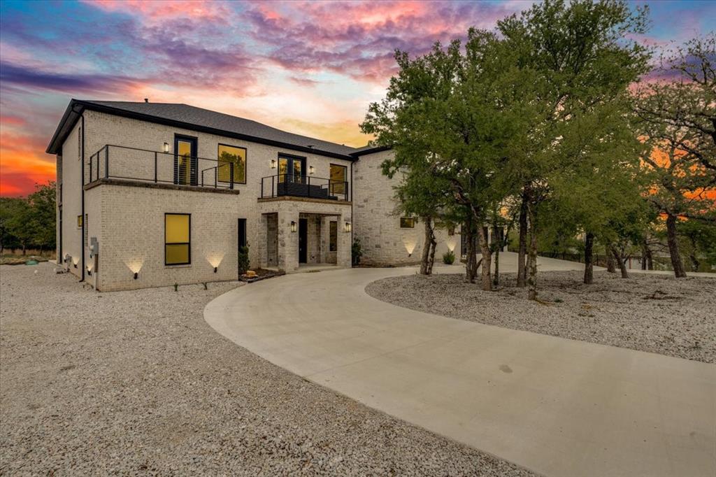 Stunning new custom construction inside the gated North Star Pointe community on Lake Bridgeport. This elegant, open-plan home centers on a chef’s kitchen with premium GE Café appliances and flows effortlessly to generous living and entertaining spaces. Two large primary-style suites are located on the main level for flexible living, while the upstairs hosts two additional bedrooms, two full baths and three private balconies with peaceful views. Outside, an expansive covered patio and built-in firepit create an inviting outdoor living area ideal for entertaining or quiet evenings. Set on a private, beautifully landscaped lot with community amenities including a pool, pickleball courts and a private boat ramp. Exceptional lakeside living — book your showing today.