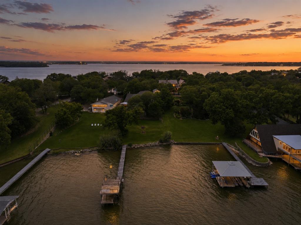 Eagle Mountain Lake living at its best awaits you on Dickson Road. This gorgeous lot is .65 acre with over 100 ft of water frontage and deep water at dock. A 4100 square foot lake home with boat-loads of character is ready for your imagination and renovation or you may choose to start fresh with a new build. The classic lake house has 4 bedrooms, 3.5 bathrooms, an elevator and 2 car garage. There is a separate workshop with an office above. Do not miss out on this great property. The sellers will consider all offers. Buyer will be responsible for obtaining a survey.