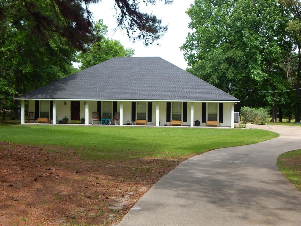 Gorgeous 4 bedroom, 2 bath house on nearly 5 acres with a 20' x 31' shop, 1 acre pond, concrete driveway, 2 car garage. covered porch all the way across front of the house. Beautiful shade trees, awesome landscaping, Shop is insulated with electricity, Open floorplan, Wood burning fireplace in living area with blower. Hand scraped hardwood floors, Crown molding, Stainless appliances, lots of storage in the attic, could be made into a huge room up there. Large closets, central heat and ac. and more.
