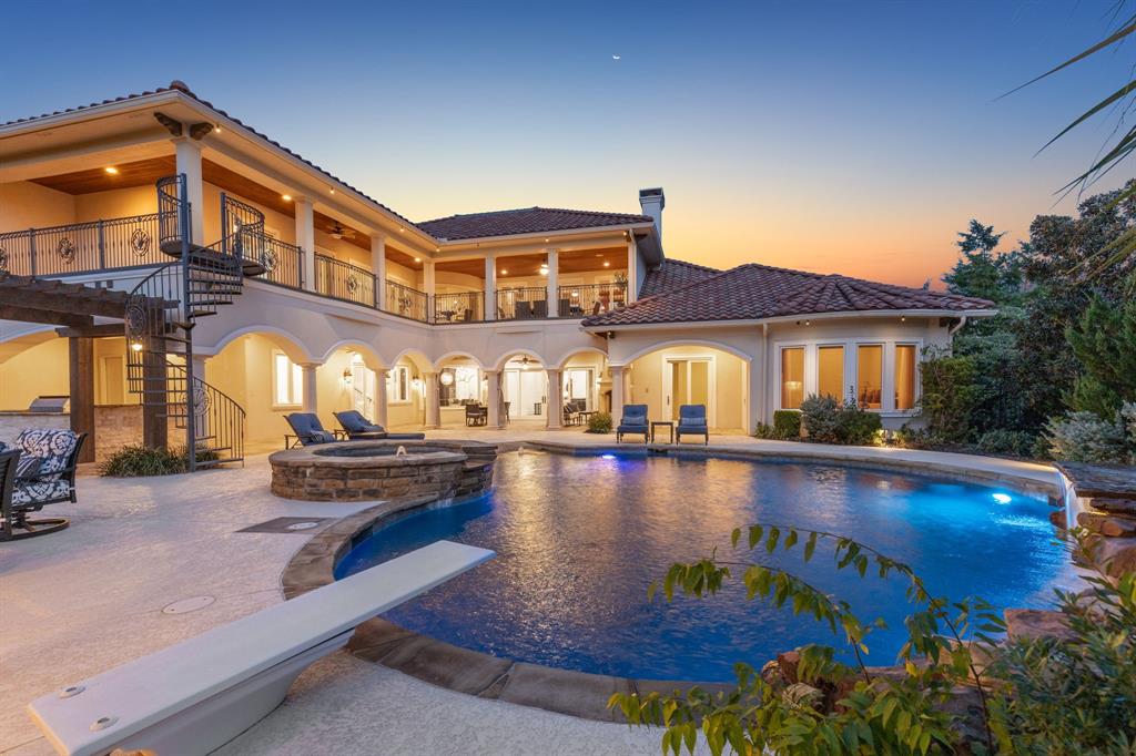 Luxurious estate tucked away on almost an acre in the upscale guard-gated community of Montserrat. Step inside & prepare to be amazed at the extraordinary floor plan & craftsmanship throughout. Become the ultimate entertainer or privately enjoy this lavish retreat. Featuring a magnificent movie theater, two bars, a gym, two laundry rooms, plus so much more to discover. This incredible residence wraps around the backyard, allowing for breathtaking views of the sparkling pool & oasis from most rooms. The outdoor living is outfitted with a beach-style pool & grotto, two fireplaces, & master grilling area - almost 2,500 square feet of covered space. Open up the all-glass doors for a versatile outdoor-indoor living experience. The grand kitchen is equipped with Thermador & Sub Zero appliances, a massive granite island with an ice maker, refrigeration drawers, & secret pantry room! Enjoy a rare 4-car temperature-controlled garage with granite flooring & multiple storage rooms.