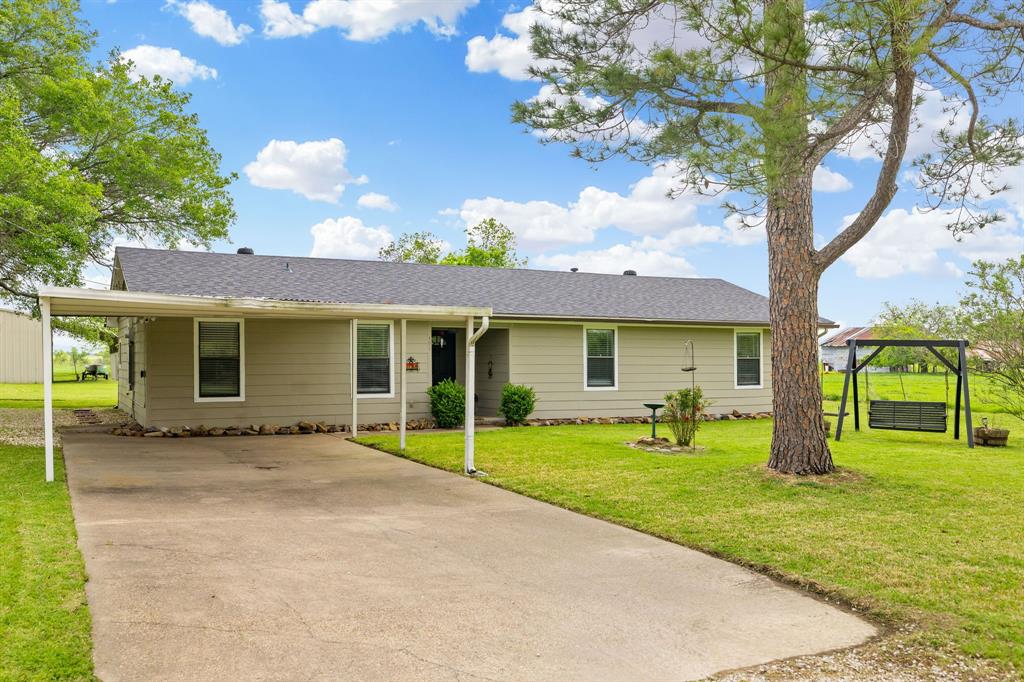 0.53-acre lot • 24x36 workshop with electricity • Boat + RV parking
Single-story 3-bedroom, 2-bath home on 0.53 acres in McLendon Chisholm with no HOA. 1,791 sq ft of open-concept living with vaulted ceilings, luxury vinyl plank flooring throughout, and fresh interior paint — move-in ready. Kitchen features granite countertops, kitchen island, white cabinetry, black subway tile backsplash, stainless steel appliances, pantry, and eat-in space. Second living and dining area with vaulted ceilings flows from the kitchen. Covered back patio with pasture views and mature trees. Utility room with sink and space for additional freezer. Attached front carport plus a separate driveway leading to a 24x36 workshop with electricity. Additional detached carport accommodates boat, RV, or oversized vehicle parking. Aerobic septic system. Rain gutters and storage included. Approx. 2.5 mi to Chisholm Country Store and Café on SH 205. Approx. 8.0 mi to Rockwall dining and shopping including Tom Thumb, Kroger, Onassis Greek Taphouse, and Huckabees Coffee. Approx. 8.5 mi to Terry Park and Lake Ray Hubbard boat ramp access in Heath. Easy access to SH 205 and I-30. Rockwall ISD — Amy Parks-Heath Elementary, Cain Middle, Rockwall-Heath High.