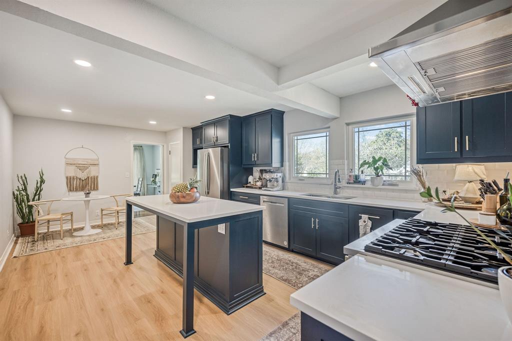 Looking for an income property, second home or family residence near TCU or hospital district? Check out this beautiful 3-bedroom, 3-full bath home in sought-after Ryan Place—where classic character meets modern updates. Original hardwood floors and abundant natural light from large picture windows create a warm, inviting feel from the moment you step inside. At the heart of the home, the chef’s kitchen is built for both function and connection—featuring professional-grade appliances, including a Monogram 6-burner gas range and Zephyr vent hood—an exceptional feature for the area. With abundant cabinetry, open shelving, quartz countertops, and a large island with seating, the kitchen is both beautiful and functional. Whether you're preparing a quiet weeknight dinner or entertaining a crowd, this space is designed to bring everyone together. Enjoy your morning coffee in the cozy breakfast nook or unwind with dinner in the inviting dining area, where large picture windows frame beautiful, tree-filled views. A vintage bathroom adds character and a touch of timeless appeal. With two bedrooms offering ensuite baths, the layout provides flexibility and privacy—ideal for roommates, guests or multigenerational living. In addition, the bonus room would make an ideal work-from-home space, nursery, library, wine room or more. Step outside to a peaceful, shaded patio and fenced yard—perfect for relaxing or entertaining. The corner lot offers added space and curb appeal, along with a rare attached side-entry 2-car garage with extra storage—perfect for keeping everything organized. Ideally located with easy access to major highways. You are close top dining such as Hurtado, Teddy Wongs and more. TCU, hospitals and downtown Fort Worth are minutes away. With major system updates already completed, you can enjoy peace of mind and focus on making this home your own.