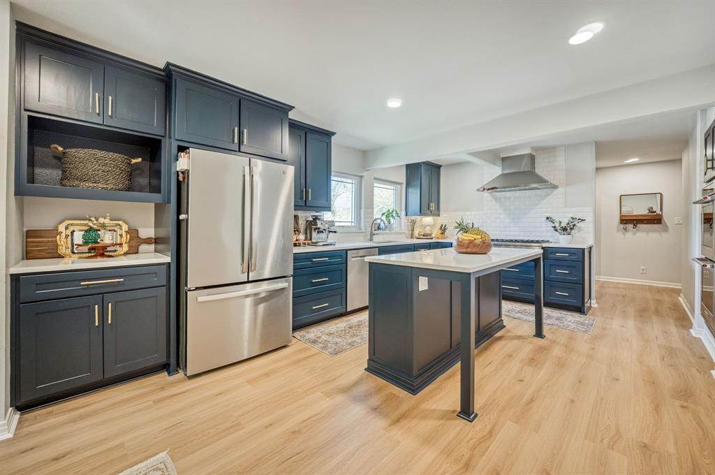 Beautiful 3-bedroom, 3-full bath home on a premium corner lot in sought-after Ryan Place—where classic character meets modern updates. Original hardwood floors and abundant natural light from large picture windows create a warm, inviting feel from the moment you step inside. At the heart of the home, the chef’s kitchen is built for both function and connection—featuring professional-grade appliances, including a Monogram 6-burner gas range and Zephyr vent hood—an exceptional feature for the area. With abundant cabinetry, open shelving, quartz countertops, and a large island with seating, the kitchen is both beautiful and functional. Whether you're preparing a quiet weeknight dinner or entertaining a crowd, this space is designed to bring everyone together. Enjoy your morning coffee in the cozy breakfast nook or unwind with dinner in the inviting dining area, where large picture windows frame beautiful, tree-filled views. A vintage bathroom adds character and a touch of timeless appeal. With two bedrooms offering ensuite baths, the layout provides flexibility and privacy—ideal for guests or multigenerational living. In addition, the bonus room would make an ideal work-from-home space, nursery, library, wine room or more. Step outside to a peaceful, shaded patio and fenced yard—perfect for relaxing or entertaining. The corner lot offers added space and curb appeal, along with a rare attached side-entry 2-car garage with extra storage—perfect for keeping everything organized. Ideally located with easy access to major highways, you’re just minutes from top dining, shopping, coffee shops, and local attractions including the Fort Worth Zoo—putting all the excitement Fort Worth has to offer right at your fingertips. With major system updates already completed, you can enjoy peace of mind and focus on making this home your own. This is a rare opportunity to own a beautifully updated, timeless home in one of Fort Worth’s most iconic and welcoming communities.