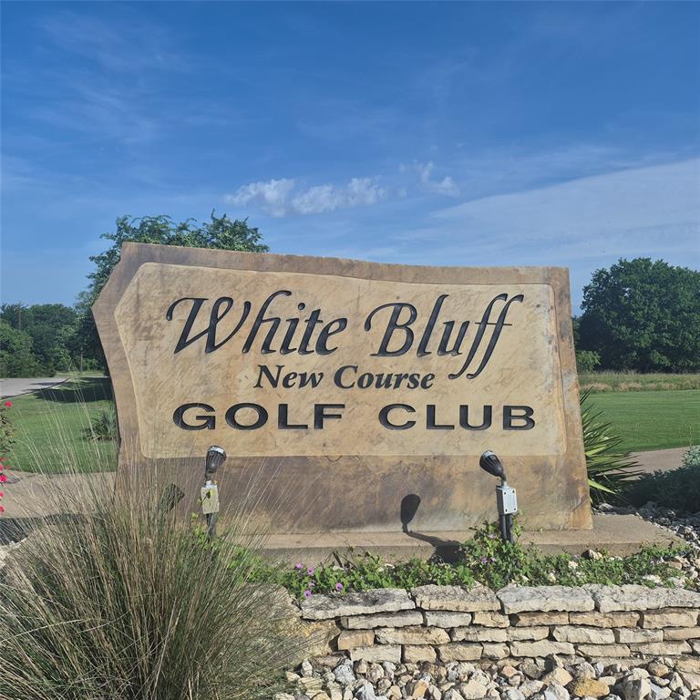 Build your dream home in the beautiful, gated community of White Bluff Resort on the shores of Lake Whitney! This flat, heavily treed homesite offers the perfect setting for a custom home, providing both privacy and natural beauty. Conveniently located just around the corner from one of the resort's two championship 18-hole golf courses, this undeveloped lot is ready whenever you are.  White Bluff is a 24-hour gated community offering an exceptional lifestyle with outstanding amenities, including 36 rounds of golf annually, four swimming pools, tennis courts, on-site dining, a full-service marina, and easy access to Lake Whitney. Whether you're ready to build now or prefer to invest for the future, you can enjoy all the community amenities while planning your dream home. White Bluff offers the flexibility to choose your own custom builder when you're ready to begin construction.  Per White Bluff regulations, there is no sign located on the property.