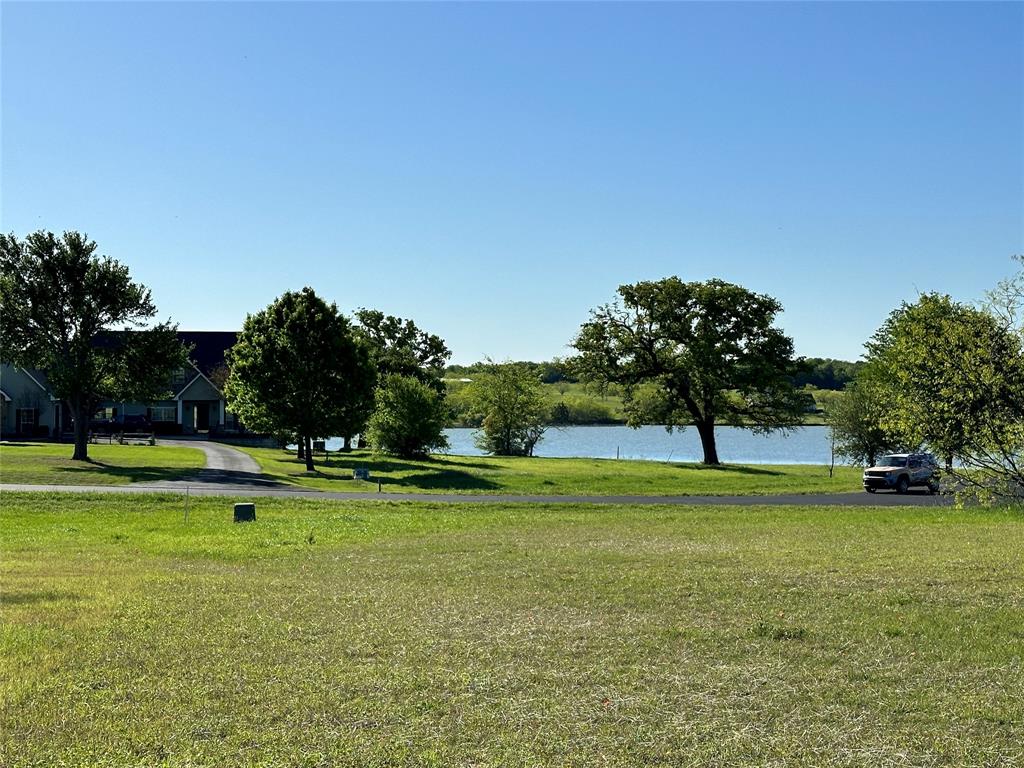 Lot 81 Moonlight Bay Court is an off water lot with fantastic lake views...without the water front price! With a higher elevation in the center of a peninsula you'll be treated to amazing sunrises and sunsets, so make sure your dream lake house plans include plenty of porches! With a little over an acre, you'll have plenty of space to create whatever you can imagine here. This nicely cleared lot is located in a quite cul-de-sac in Southpoint, a gated community on Richland Chambers Lake. This subdivision restricts to site built homes with a minimum square footage of 1,600-2,000 square feet depending on level and there is no time frame to build. This lovely community provides a pool and pavilion area for it's residents, as well a boat ramp and pier! So no need to sacrifice any time out on the lake doing what you love just because this lot is off water. Get ready to get lost in a world made of water, sunsets , and endless memories.
