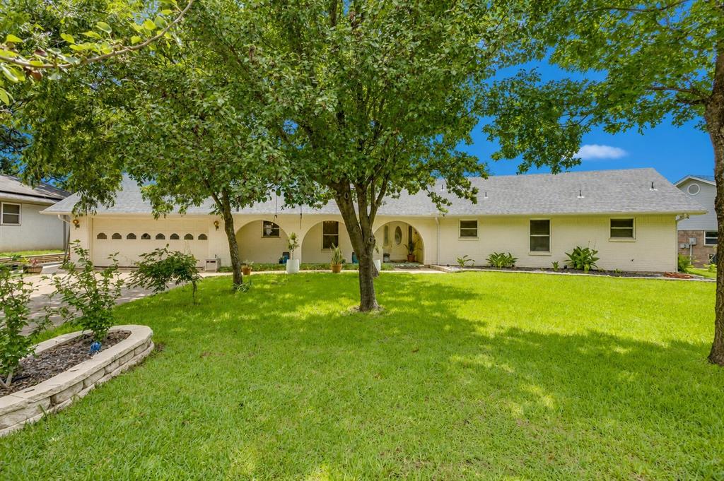 Welcome home to this beautifully maintained 4-bedroom, 3 full bathroom home featuring a dedicated office or game room, offering the flexibility today’s buyers are looking for. Pride of ownership is evident throughout, with numerous updates and thoughtful details around every corner. Situated on a huge lot shaded by mature trees, including fruit and pecan trees, this property offers both beauty and functionality. The lush St. Augustine lawn creates incredible curb appeal, while the privacy-fenced backyard includes a storage building for added convenience. Inside, you'll find spacious living areas, a warm and inviting living room anchored by a fireplace, a formal dining room with custom built-ins, a separate breakfast area, and a private room just off the foyer that is perfect for a home office, playroom, or second living space. Additional features include built-ins throughout the home, new flooring throughout most of the house (excluding bedrooms), separate HVAC systems and water heaters for the living and bedroom areas, and an abundance of storage. Located in a highly sought-after subdivision, this home combines comfort, character, and functionality in a setting that rarely becomes available. A true must-see!