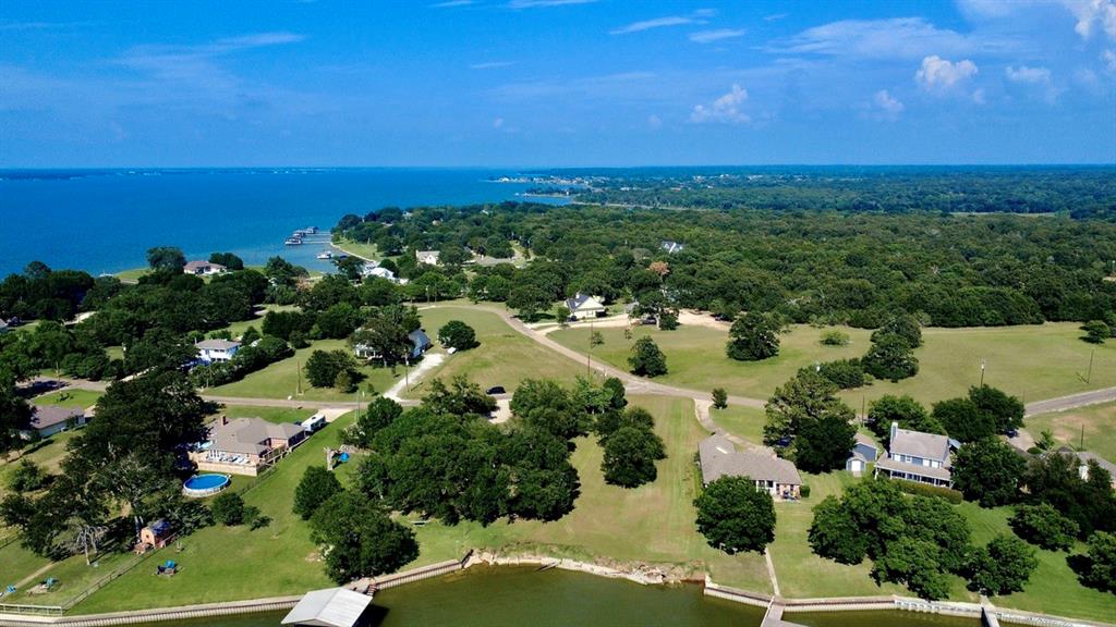 Discover your own slice of paradise on beautiful Richland Chambers Lake in the sought-after Rustling Oaks subdivision! This stunning waterfront lot offers over 130 feet of lake frontage, creating the perfect setting for your dream lake home. Retaining wall needs to be replaced at buyer's expense. Imagine waking up to breathtaking sunrises and winding down with unforgettable Texas sunsets reflecting across the water. Enjoy the peaceful lake lifestyle with community amenities including a fishing dock and lake access, perfect for boating, fishing, relaxing, and making lifelong memories. Mature surroundings and tranquil views make this property feel like a true retreat while still being conveniently located near Fairfield and Corsicana amenities. Whether you are looking for a weekend getaway or a full-time waterfront escape, this property offers endless potential to build the custom home you have always envisioned. CCRs available in Transaction Desk. Come experience the beauty, serenity, and charm of Richland Chambers Lake and make this incredible waterfront property your own!