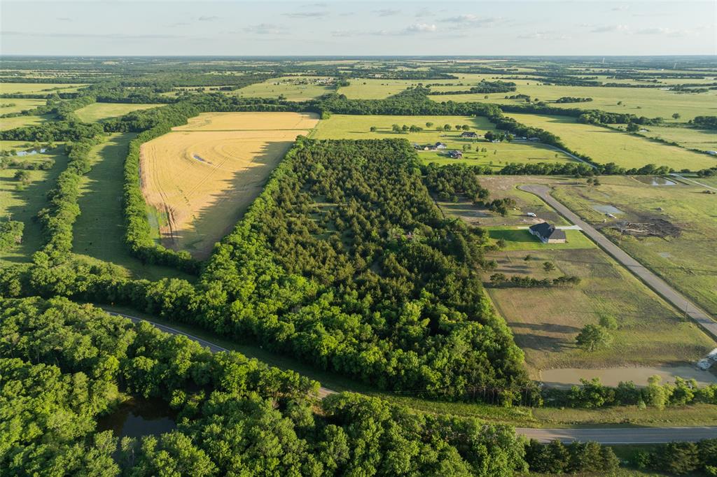 Located just outside the city limits of Leonard in growing Fannin County, this 15.78-acre tract offers an excellent opportunity for future residential development, investment, or a private homesite. With frontage along a Farm-to-Market road and nearby utilities in the area, the property combines accessibility with a Texas Country setting that is increasingly difficult to find.
Mostly wooded with level topography, this property provides flexibility for a variety of potential uses. An older home currently sits on the property and is considered to have little to no contributory value, making this a true land-focused offering with a clean slate for future improvements.
Surrounding development activity continues to support long-term potential in this area, including neighboring acreage that is currently being developed into a residential neighborhood. Whether intended for a single estate property, multiple homesites, or future development, this tract is well-positioned in one of North Texas’ steadily growing corridors.
Important to note, while portions of the surrounding area contain floodplain, this property is not located within a FEMA flood zone — a valuable designation for future planning and development.
