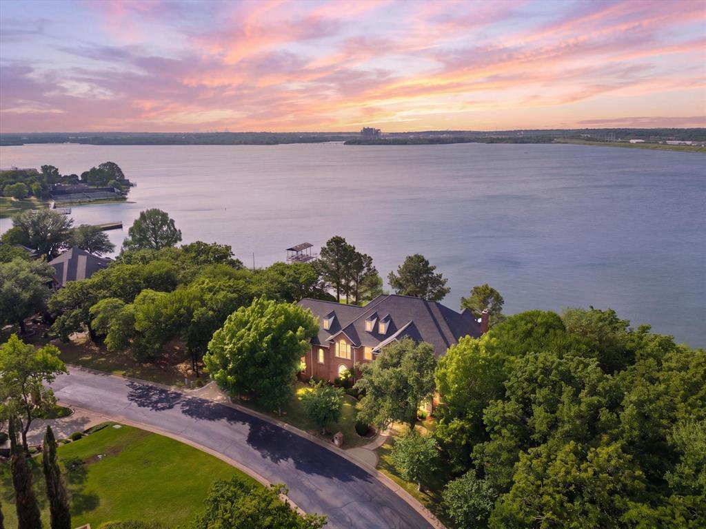 Luxury lake living at its finest—where every day feels like a getaway. Welcome to your private lakefront retreat in the exclusive gated community on Lake Arlington. This beautifully updated home has been thoughtfully redesigned with high-end finishes and extensive upgrades throughout, including new flooring, fresh interior paint, new cabinetry, a stunning island with marble countertops, brand-new appliances, all new air ducts, and two new HVAC systems.

Panoramic windows span the entire back of the home, showcasing breathtaking water views while filling the space with natural light.

Designed for both everyday living and effortless entertaining, the property features a sparkling pool and expansive outdoor living areas perfect for hosting or relaxing in a serene setting. Situated on a large, private lot, this home offers exceptional privacy and a true escape from the everyday.

Residents enjoy exclusive access to a private community dock and clubhouse, adding convenience and enhancing the lake lifestyle. This rare, move-in-ready home combines luxury, comfort, and unbeatable views—an exceptional opportunity on Lake Arlington.