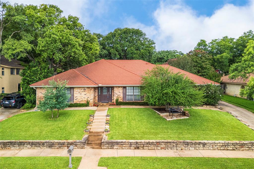 Vacation inspired living awaits in the sought-after Enchanted Lake Estates community.  This custom built one-story home offers warmth, character and effortless entertaining.  Rich 3 quarter-inch red oak hardwood floors flow throughout while the updated kitchen features granite counter tops, stainless steel appliances, gas cooking and a new double oven and beautifully refreshed cabinetry.  The spacious living room is anchored by a stunning stone fireplace, creating a warm and inviting gathering space.  The private primary suite offers dual vanities, two walk-in closets, a relaxing jetted tub, and separate shower.  Split secondary bedrooms share a convenient Jack-and-Jill bath, and a versatile flex room provides endless possibilities as a home office, media room, play room or exercise space.  Step outside and discover an entertainer’s paradise.  Enjoy a sparking pool with tanning shelf, large covered patio, expansive screened porch and professionally landscaped grounds designed for year-round enjoyment.  Energy efficient features include a steel roof, radiant barrier and storm windows for added peace of mind.  Nestled in a picturesque lakeside community with breathtaking views of Lake Arlington, residents enjoy resort-style amenities including a community pool, clubhouse, tennis and pickle ball courts and private boat launch.  Every day feels like a getaway in this exceptional home where comfort and recreation come together beautifully.