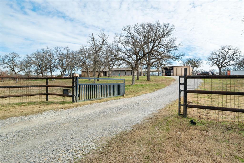 Discover the perfect blend of tranquility and convenience with this recently renovated ranch-style home on 19.98 picturesque acres.  In 2015 , the home was gutted to the studs, remodeled and rewired, ensuring modern safety and comfort. Over the past year, it has received a new roof and fresh exterior paint, and within the last three months, new flooring and interior paint have been added for a polished move-in ready finish. This property featurs three stock tanks, fencing, cross fencing, a spacious 18X30 insultaed workshop,  a 30X50 barn with an additional 600 sq. ft. seperate living quarters, and a RV hookup offering plenty of versatility. Nestled in a peaceful location outside city limits yet just minutes from all that bustling Mineral Wells has to offer, this home offers the ideal setting for quiet country living with modern amenities.  Don't miss this opportunity to own a truly turn-key property ready for its next chapter.