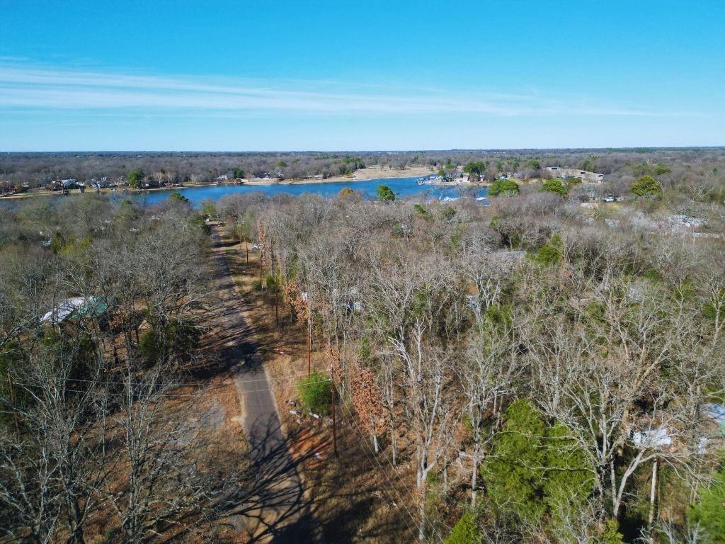 One of four adjacent lots in Hidden Hills Harbor within walking distance of the lake and a secluded community beach. Located in a quiet, established lake community approximately one hour from Dallas and Tyler, this property offers a peaceful, nature-filled setting ideal for a full-time home, weekend retreat, or investment opportunity. Buyer and buyer’s agent to verify all information, including utilities, restrictions, and intended use.