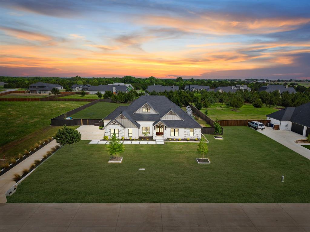 NO CLOSING COST LOAN OPTION AVAILABLE THROUGH PREFERRED LENDER. Contact listing agent for details.
Exceptionally well maintained one owner custom home by LMC Custom Homes situated on a full one acre lot in Waxahachie within the Estates of Hidden Creek. This property offers quality craftsmanship, thoughtful design, and the valuable benefit of no city taxes.

The home features four bedrooms, two and a half bathrooms, a dedicated office, and a spacious game room, providing flexibility for a variety of lifestyles. The open floor plan is filled with natural light and showcases specialty ceilings beginning with an impressive foyer entry. Hand scraped hardwood floors add warmth and character throughout the main living areas. The main living area is highlighted by a floor to ceiling stone fireplace and flows seamlessly into the kitchen, creating an ideal layout for everyday living and entertaining. The kitchen features custom cabinetry extending to the ceiling, a large sit in island, quartz countertops, and timeless farmhouse inspired finishes designed for both style and function. The primary suite offers a private retreat with a well appointed bathroom and an oversized walk in closet. Secondary bedrooms are spacious and thoughtfully arranged. The large backyard provides ample space to create a personalized outdoor setting, whether for relaxing, entertaining, or future improvements, all within the privacy of a one acre lot. The garage floor has been upgraded to a Polyaspartic floor to create the perfect functional space and the extended concrete on the back patio offer tons of potential for expansion!

Located in a desirable area of Waxahachie, this home combines space, comfort, and long term value in a peaceful setting. Homes of this quality and condition on acreage with no city taxes are a rare find.