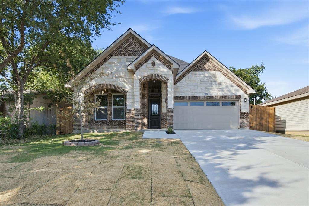 The kind of new construction buyers hope to find—but rarely do. Wrapped in a timeless blend of natural limestone and rich brick, this Modern Texas Hill Country-inspired home delivers curb appeal that's anything but ordinary. Step inside to soaring vaulted ceilings with exposed wood beams, a striking fireplace, custom millwork, designer lighting, and warm natural finishes that create a space both elevated and inviting. At the heart of the home, the chef-inspired kitchen features a statement island, custom cabinetry, walk-in pantry, and seamless flow into the light-filled living and dining areas—perfect for everyday living and entertaining alike. The oversized primary suite offers a spa-like retreat with a beautifully appointed bath and expansive walk-in closet. Set on a generous homesite shaded by mature trees, this home offers the rare combination of brand-new construction with the charm of an established neighborhood, all just minutes from Downtown Fort Worth, the Historic Stockyards, and major commuter routes.