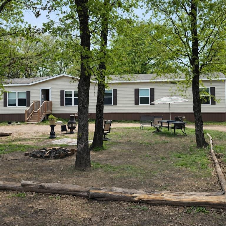 Built in 2018, this spacious double-wide home sits on two lots and offers 4 bedrooms, 2 bathrooms, and 2 living areas. The front living room flows seamlessly into the dining area and kitchen, creating an open-concept layout that is perfect for entertaining family and friends.
The kitchen features a large walk-in pantry, providing ample storage space. The laundry room includes a convenient exterior door leading directly to the fenced backyard. An added bonus is the ceiling-mounted air vents.
Outside, you'll find three storage buildings, offering plenty of room for tools, equipment, and hobbies, along with an in-ground storm shelter for added peace of mind.
Enjoy the best of both worlds—peaceful country living with the convenience of nearby city amenities. Buyer and buyer's agent to verify all info giving.