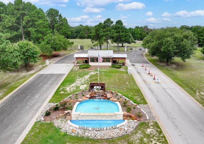 This 2.02-acre wooded corner lot is in Safari Waters Ranch, a private, gated community with 1,775 acres of forested land and home sites ranging from 1 to 5 acres. The neighborhood features three beautiful spring-fed lakes, totaling 130 acres, stocked with bass, catfish, crappie, and bream. Exotic wildlife like zebra, fallow deer, axis deer, white-tailed deer, and Pere David's deer roam freely throughout the area. Property owners and their guests can use Camp Safari RV park, which has 28 full hook-ups, a pavilion, and restrooms. There are also common areas with fishing docks, boat ramps, and lakeside picnic and grill spots. Residents enjoy a quiet country lifestyle just 90 minutes from Dallas. You can choose your own builder, there’s no time limit to build, and the property qualifies for an agricultural use exemption. This is a great place to call home or to use as a relaxing getaway.