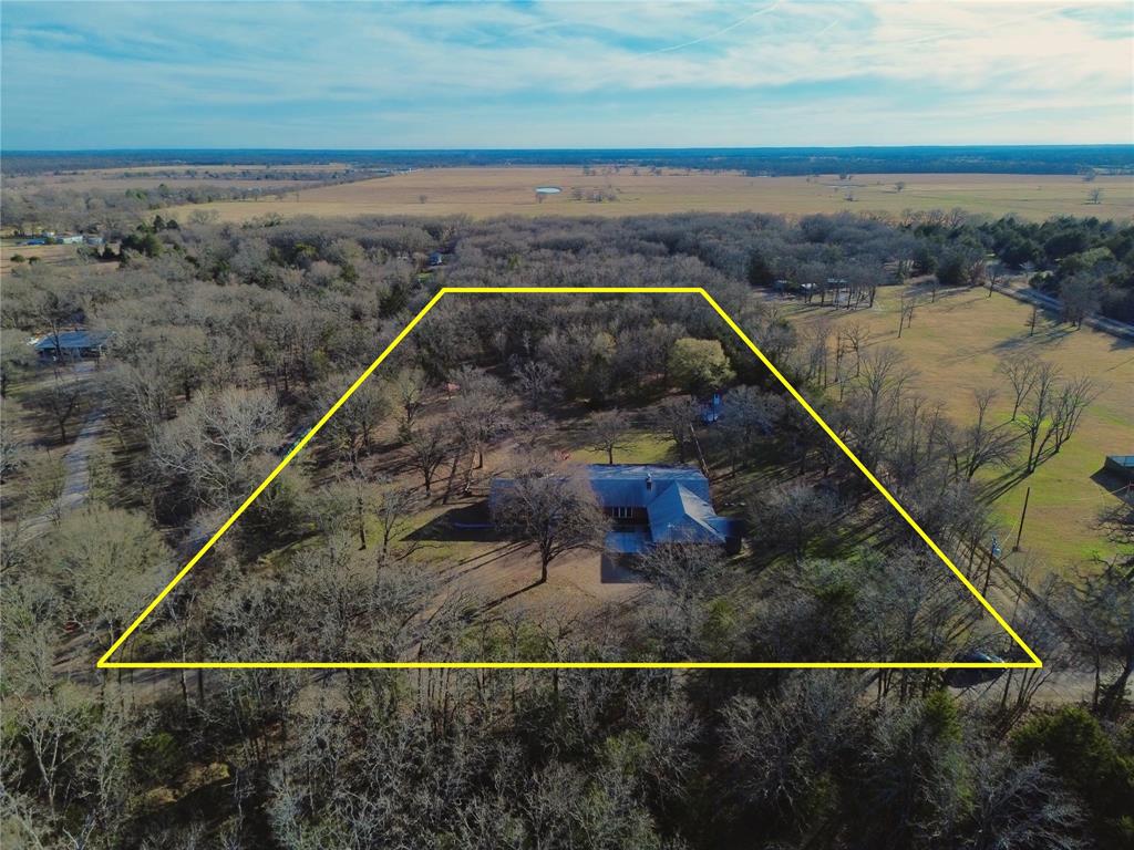 A large family retreat nestled on 5 acres with a park like setting located at Cedar Creek Lake. In the main house area, the heart of the home offers inviting gathering areas perfect for the family dinners, game nights, and celebrations. 6 bedrooms and 3 full bathrooms, along with two living spaces and separate primary bedroom makes for plenty of room to be together and still have some personal space. massive primary closet area. Bonus separate bunk room or flex space in the converted garage area with another full bathroom featuring double private shower areas offers multi-generational living possibilities. Also known as the Blue Moon, this property is currently a fully functioning SHORT TERM RENTAL with a 9.8 RATING!! It currently sleeps up to 31 guests, and owners are willing to work with new buyers to keep that high rating!! This property is located 45 minutes East of Dallas and just minutes to the public boat ramp at Cedar Creek Lake. Recent repairs include foundation, septic piping, and a new bathtub in the primary on suite. Back section of the property is still treed allowing for privacy or clearing to add your on-property features. No known restrictions. Furniture and decor package negotiable separately.
