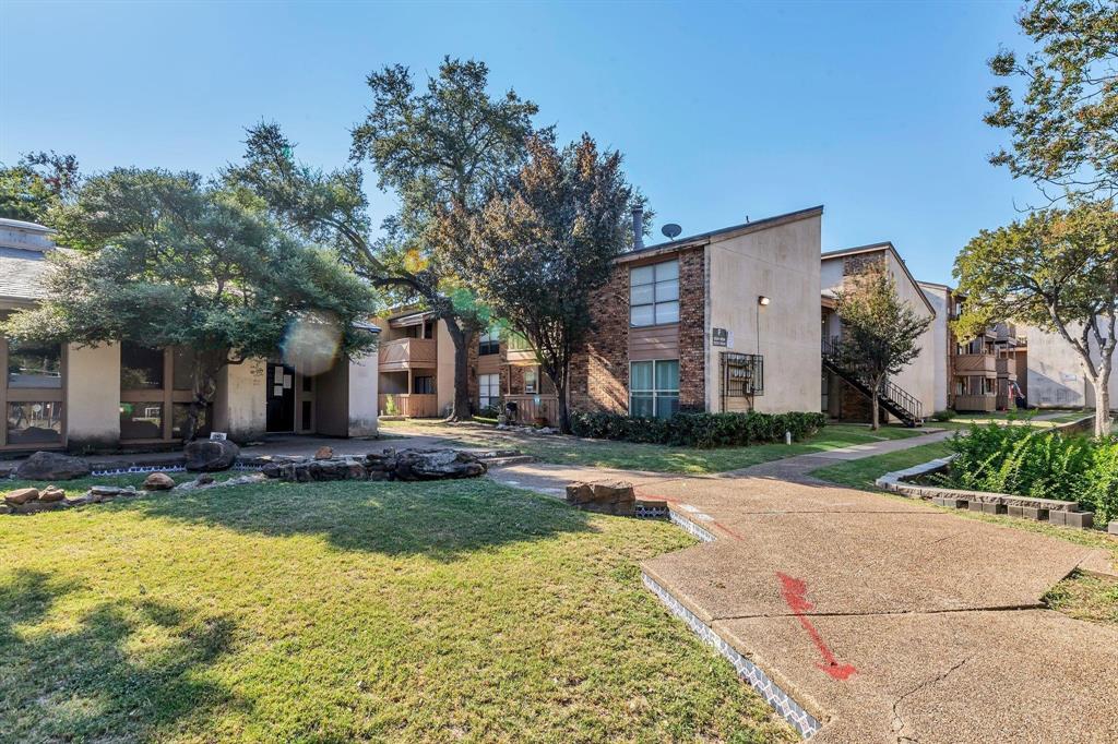 A first-floor condominium located in the gated Windtree Condos community in Lake Highlands. Property Features: 2 bedrooms and 2 full bathrooms.
Approximately 807 to 880 square feet. Key Interior Features: Spacious living room with a wood-burning fireplace. Private balcony patio area. Large floor plan with significant closet space. Laundry room designed for a full-size washer and dryer, included. Includes a recent water heater for improved efficiency. Assigned Parking: Includes dedicated parking space. Location & Community Accessibility: Centrally located with easy access to I-635 and US-75.  Education: Situated within the Richardson Independent School District (RISD). Nearby Amenities: Close to shopping, dining, and major grocery stores like La Michoacán Meat Market. Nearby parks include Richland Park and White Rock Lake. Approximately 1.2 miles from the Lake Highlands DART Station. HOA: The Windtree Condos HOA covers maintenance of grounds, water, sewer, trash and pest control.